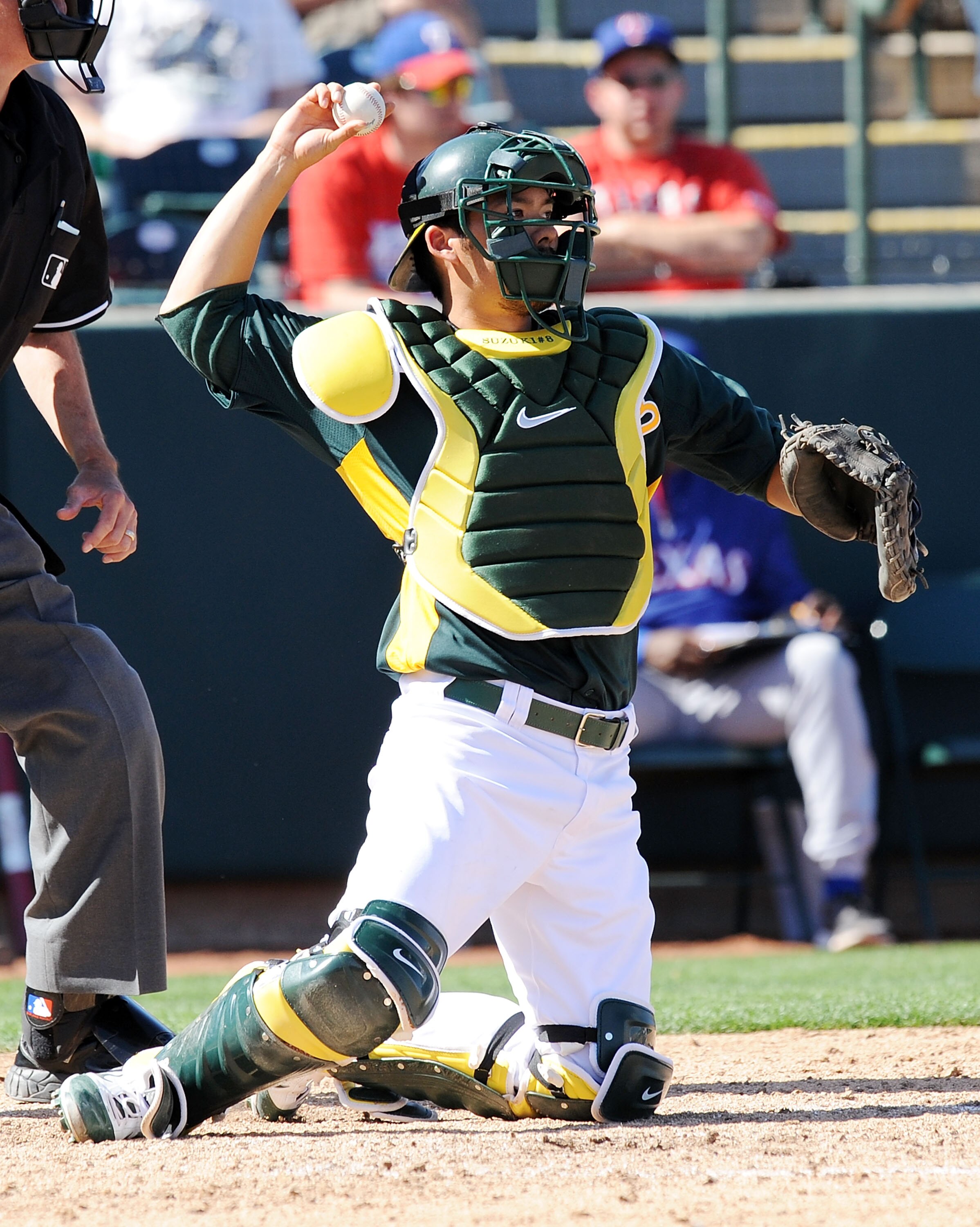 PHOENIX, AZ - MARCH 04:  Kurt Suzuki #8 of the Oakland Athletics throws the ball back to the pitcher against the Texas Rangers at Phoenix Municipal Stadium on March 4, 2011 in Phoenix, Arizona.  (Photo by Norm Hall/Getty Images)