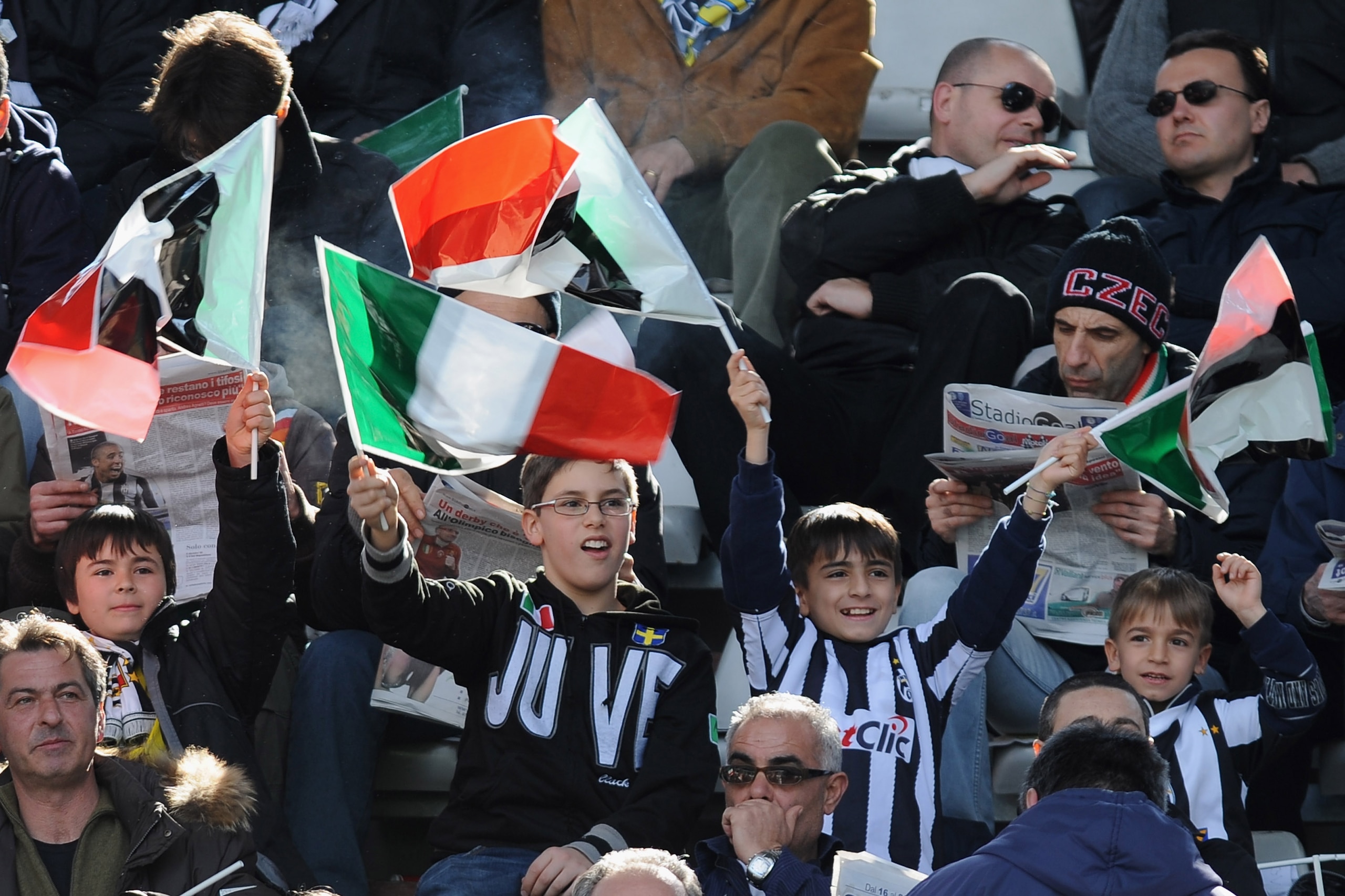 TURIN, ITALY - MARCH 20:  Juventus FC young fans wave flags during the Serie A match between Juventus FC and Brescia Calcio at Olimpico Stadium on March 20, 2011 in Turin, Italy.  (Photo by Valerio Pennicino/Getty Images)
