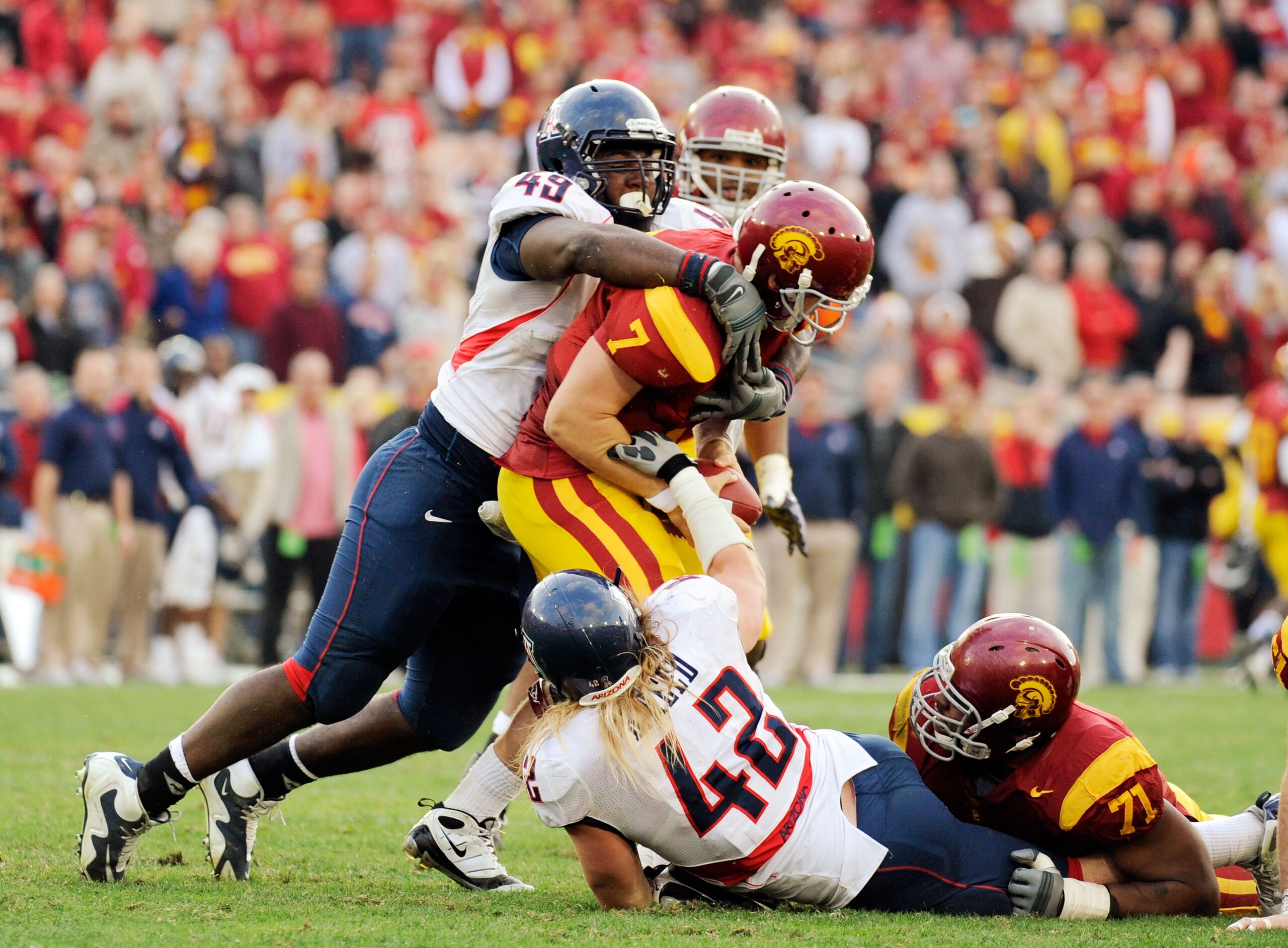 LOS ANGELES, CA - DECEMBER 05: Quarterback Matt Barkley #7 of the USC Trojans is sacked by Earl Mitchell #49 and Brooks Reed #42 of the Arizona Wildcats during the fourth quarter of the NCAA college football game at the Los Angeles Coliseum on December 5 LOS ANGELES, CA - DECEMBER 05: Quarterback Matt Barkley #7 of the USC Trojans is sacked by Earl Mitchell #49 and Brooks Reed #42 of the Arizona Wildcats during the fourth quarter of the NCAA college football game at the Los Angeles Coliseum on December 5