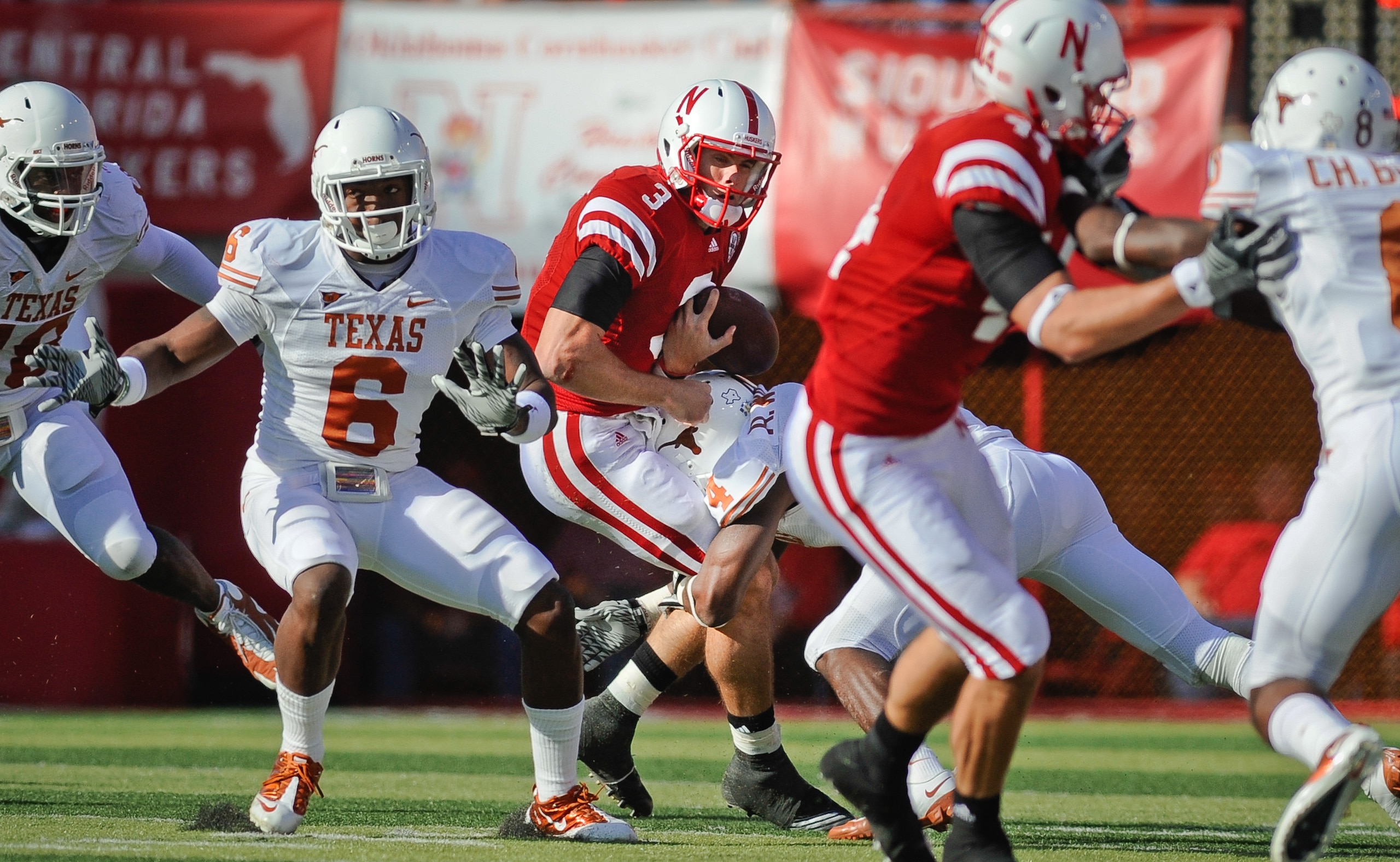 LINCOLN, NE - OCTOBER 16: Quarterback Taylor Martinez #3 of the Nebraska Cornhuskers gets the ball knocked loose by cornerback Aaron Williams #4 of the Texas Longhorns during their game at Memorial Stadium on October 16, 2010 in Lincoln, Nebraska. Texas D LINCOLN, NE - OCTOBER 16: Quarterback Taylor Martinez #3 of the Nebraska Cornhuskers gets the ball knocked loose by cornerback Aaron Williams #4 of the Texas Longhorns during their game at Memorial Stadium on October 16, 2010 in Lincoln, Nebraska. Texas D