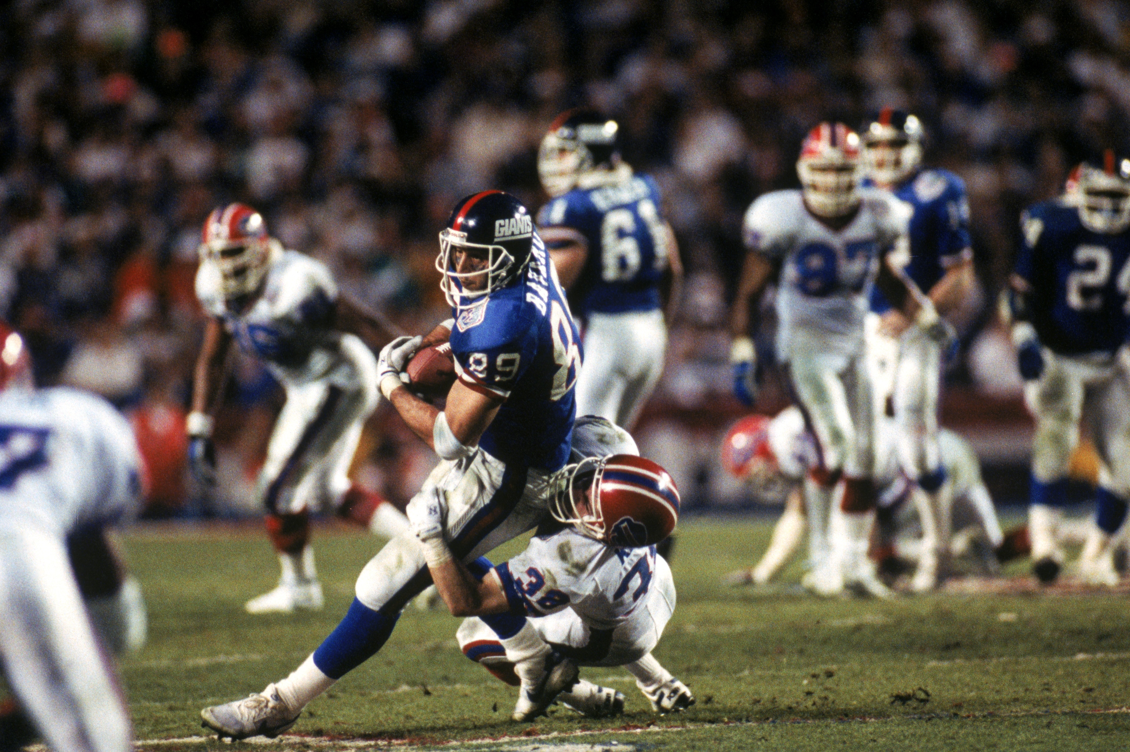 TAMPA, FL - JANUARY 27:  Tight end Mark Bavaro #89 of the New York Giants fights for yardage against safety Mark Kelso #38 of the Buffalo Bills during Super Bowl XXV at Tampa Stadium on January 27, 1991 in Tampa, Florida. The Giants defeated the Bills 20-