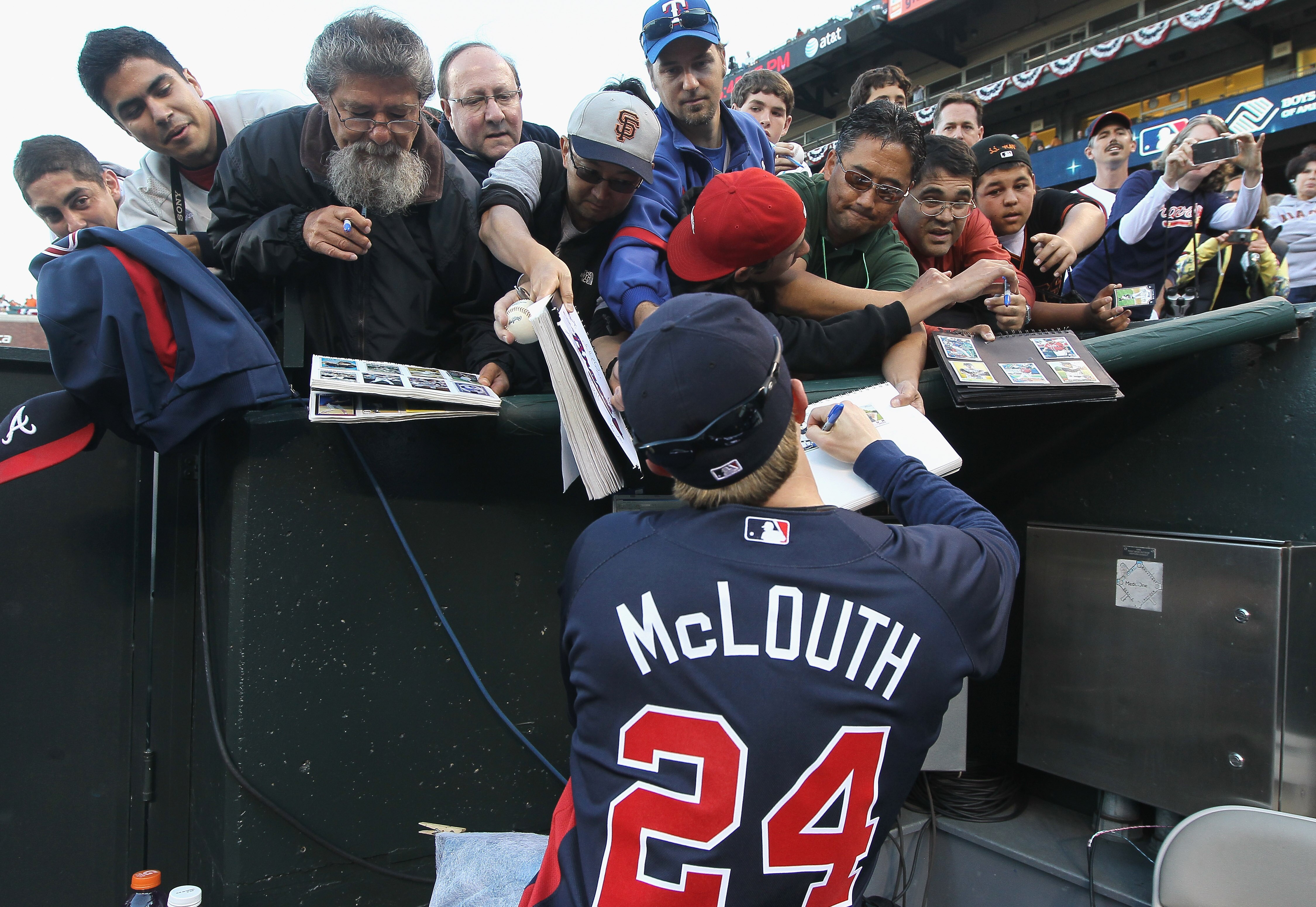 SAN FRANCISCO - OCTOBER 07:  Nate McLouth #24 of the Atlanta Braves signs autographs before the start of game one of the NLDS against the San Francisco Giants at AT&T Park on October 7, 2010 in San Francisco, California.  (Photo by Justin Sullivan/Getty I