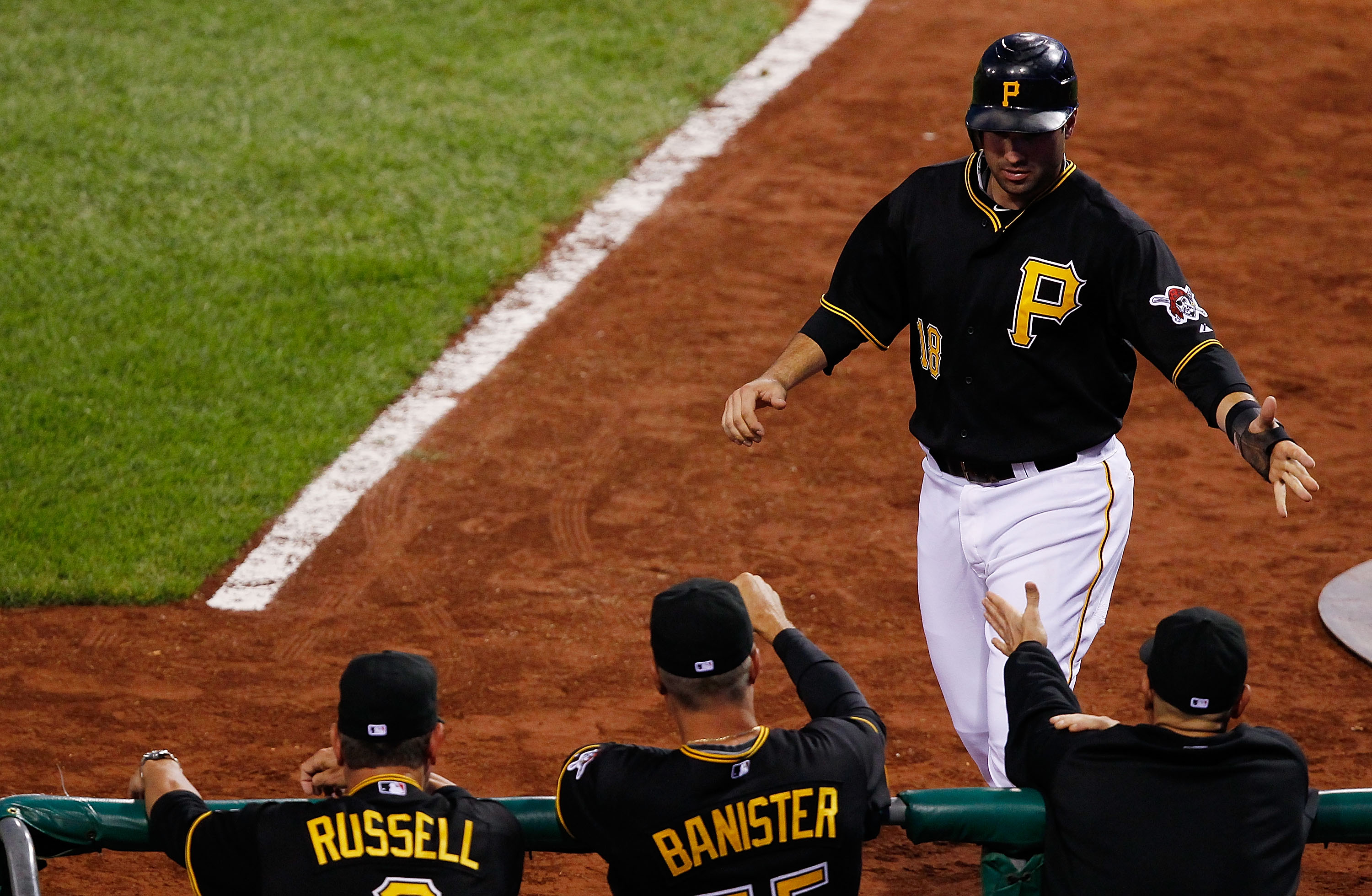 PITTSBURGH - SEPTEMBER 21:  Neil Walker #18 of the Pittsburgh Pirates is congratulated by manager John Russell #7 and pitching coach Jeff Banister #55 after scoring against the St. Louis Cardinals during the game on September 21, 2010 at PNC Park in Pitts