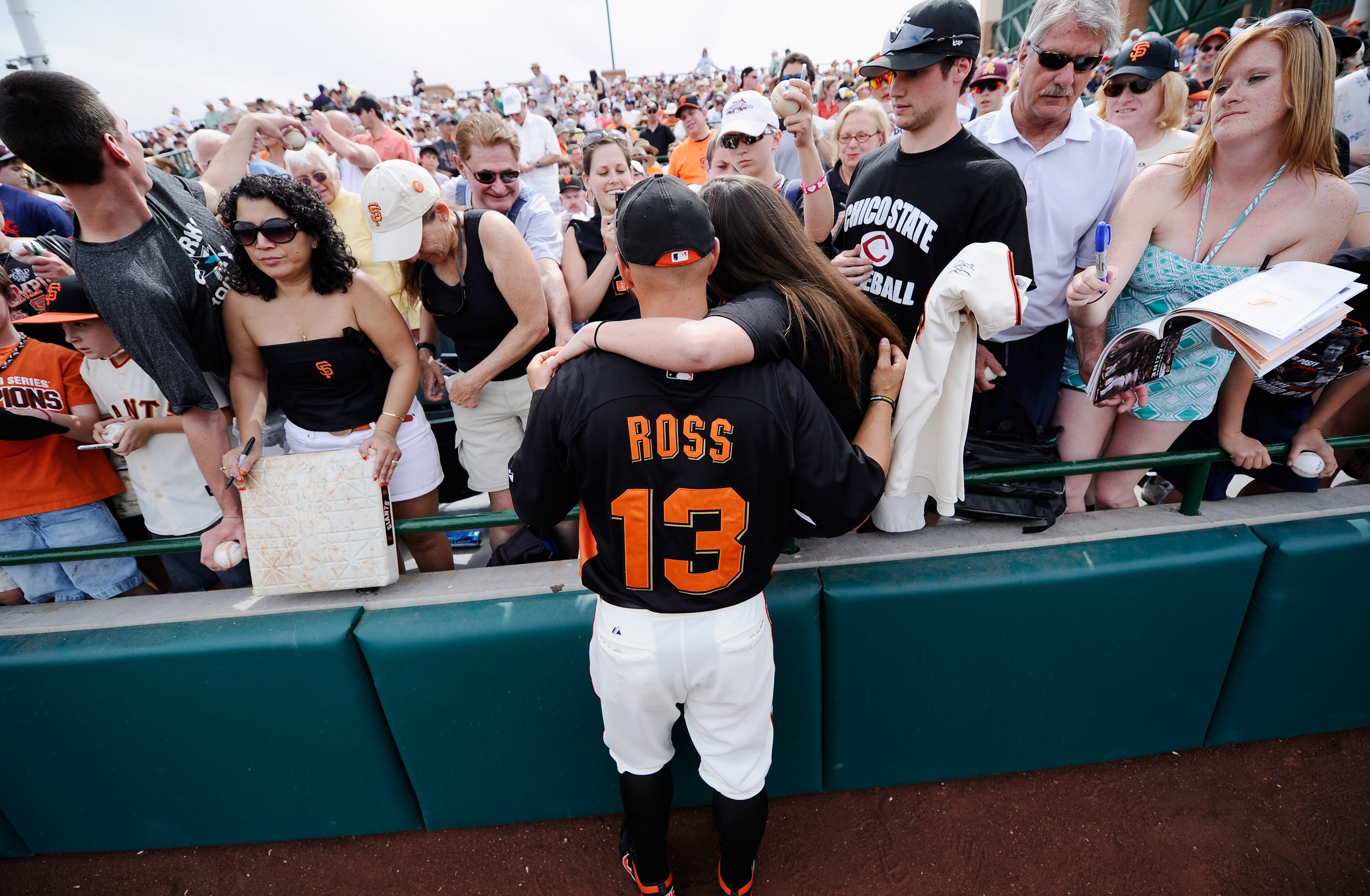 SCOTTSDALE, AZ - MARCH 14:  Cody Ross #13 of the San Francisco Giants gets his picture taken with fans priror to the start of the spring training baseball game against Milwaukee Brewers at Scottsdale Stadium on March 14, 2011 in Scottsdale, Arizona.  (Pho