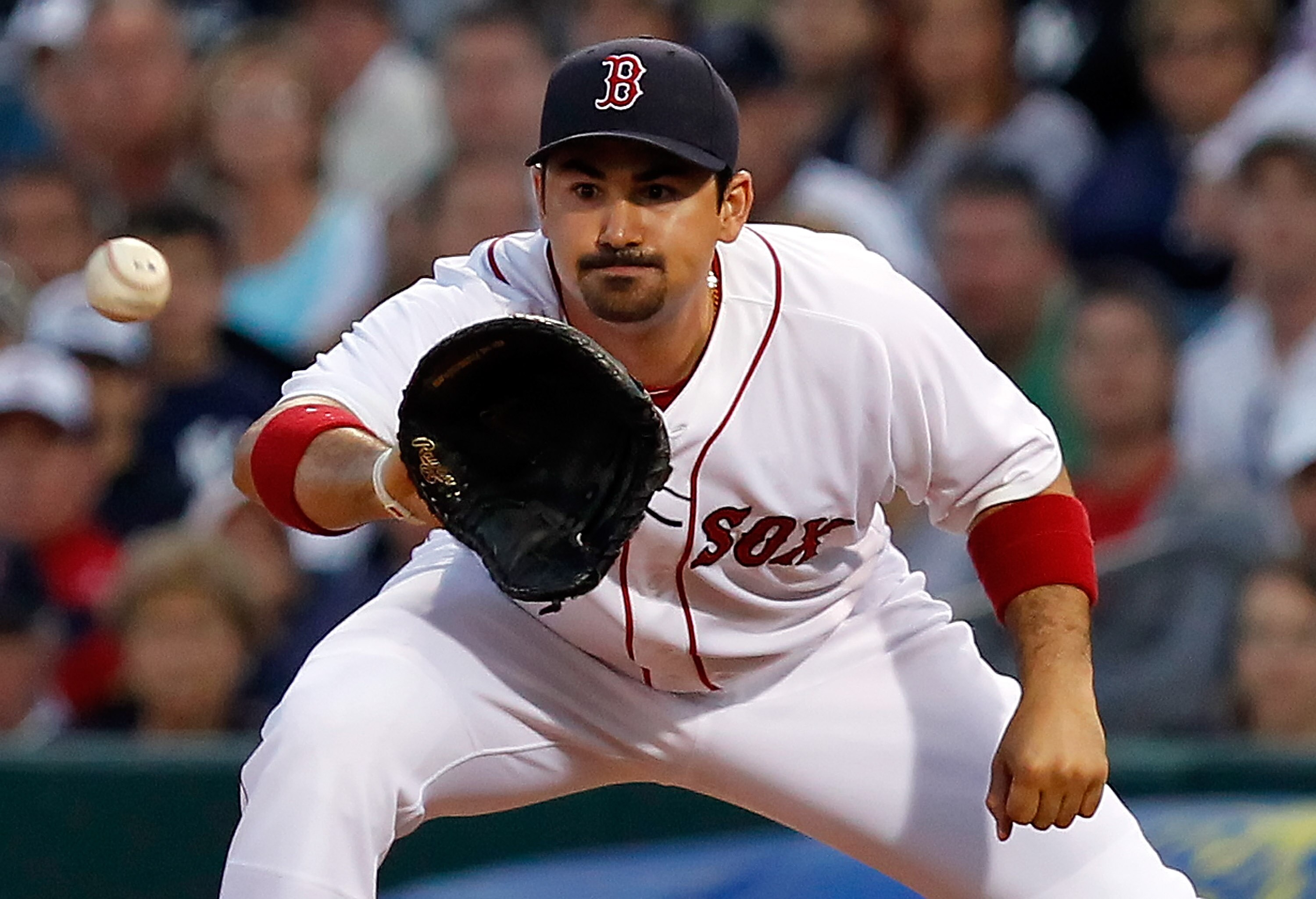 FORT MYERS, FL - MARCH 14:  Infielder Adrian Gonzalez #28 of the Boston Red Sox takes the throw at first against the New York Yankees during a Grapefruit League Spring Training Game at City of Palms Park on March 14, 2011 in Fort Myers, Florida.  (Photo b