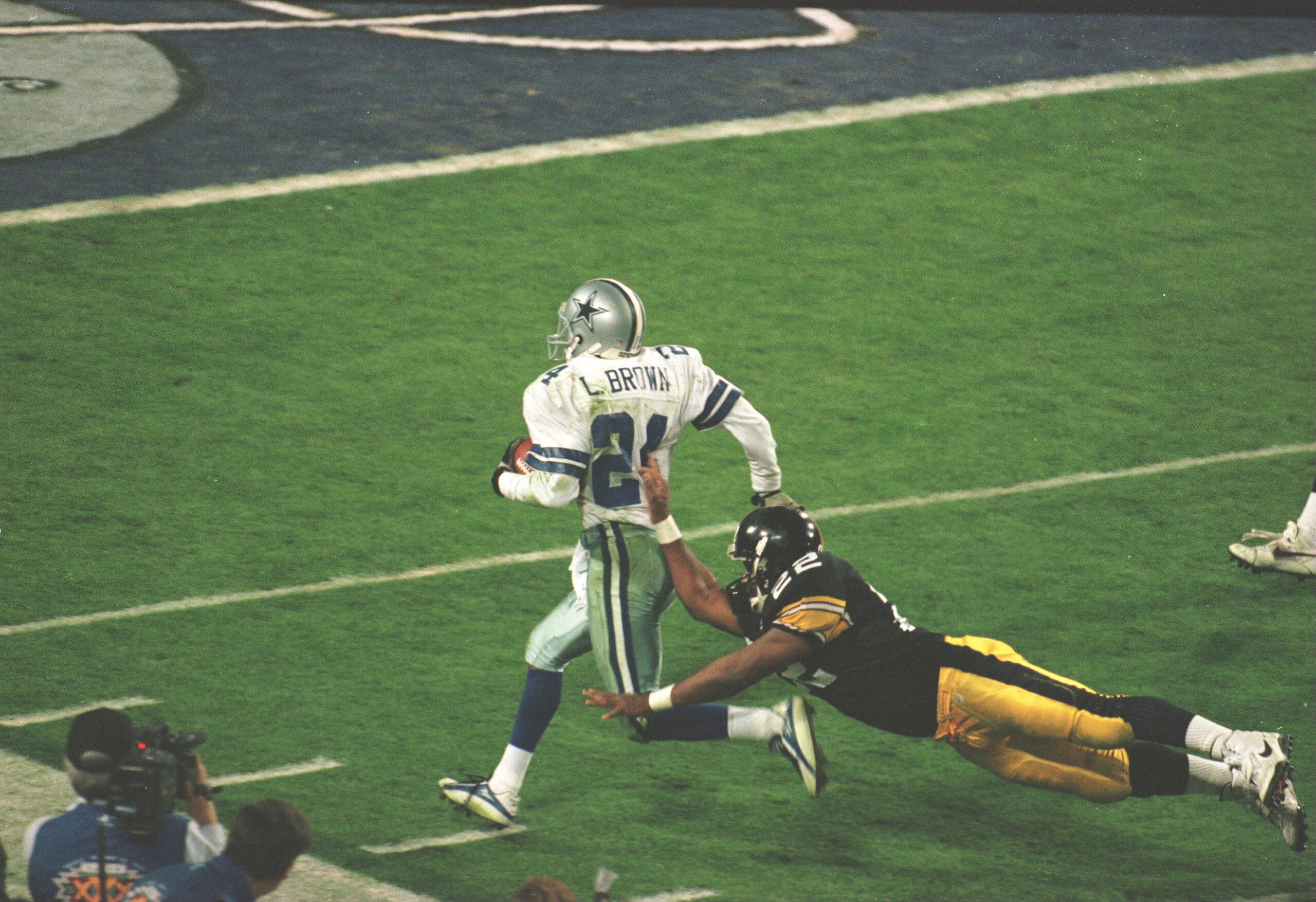28 Jan 1996:  Cornerback Larry Brown of the Dallas Cowboys is pushed out of bounds by running back John L. Williams of the Pittsburgh Steelers during the 4th quarter of the Cowboys game versus the Steelers in Super Bowl XXX at Sun Devil Stadium in Tempe,
