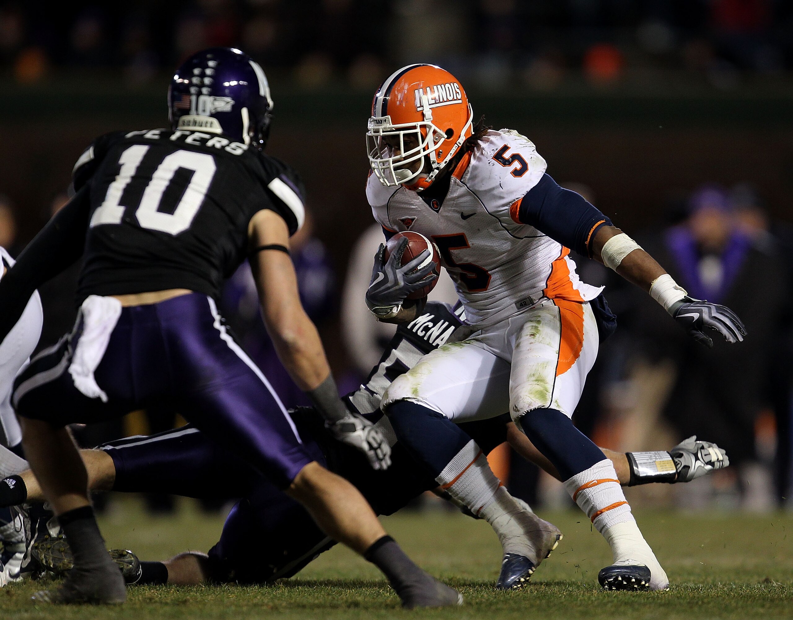 CHICAGO - NOVEMBER 20: Mikel Leshoure #5 of the Illinois Fighting Illini runs as Brian Peters #10 of the Northwestern Wildcats closes in during a game played at Wrigley Field on November 20, 2010 in Chicago, Illinois. Illinois defeated Northwestern 48-27. CHICAGO - NOVEMBER 20: Mikel Leshoure #5 of the Illinois Fighting Illini runs as Brian Peters #10 of the Northwestern Wildcats closes in during a game played at Wrigley Field on November 20, 2010 in Chicago, Illinois. Illinois defeated Northwestern 48-27.