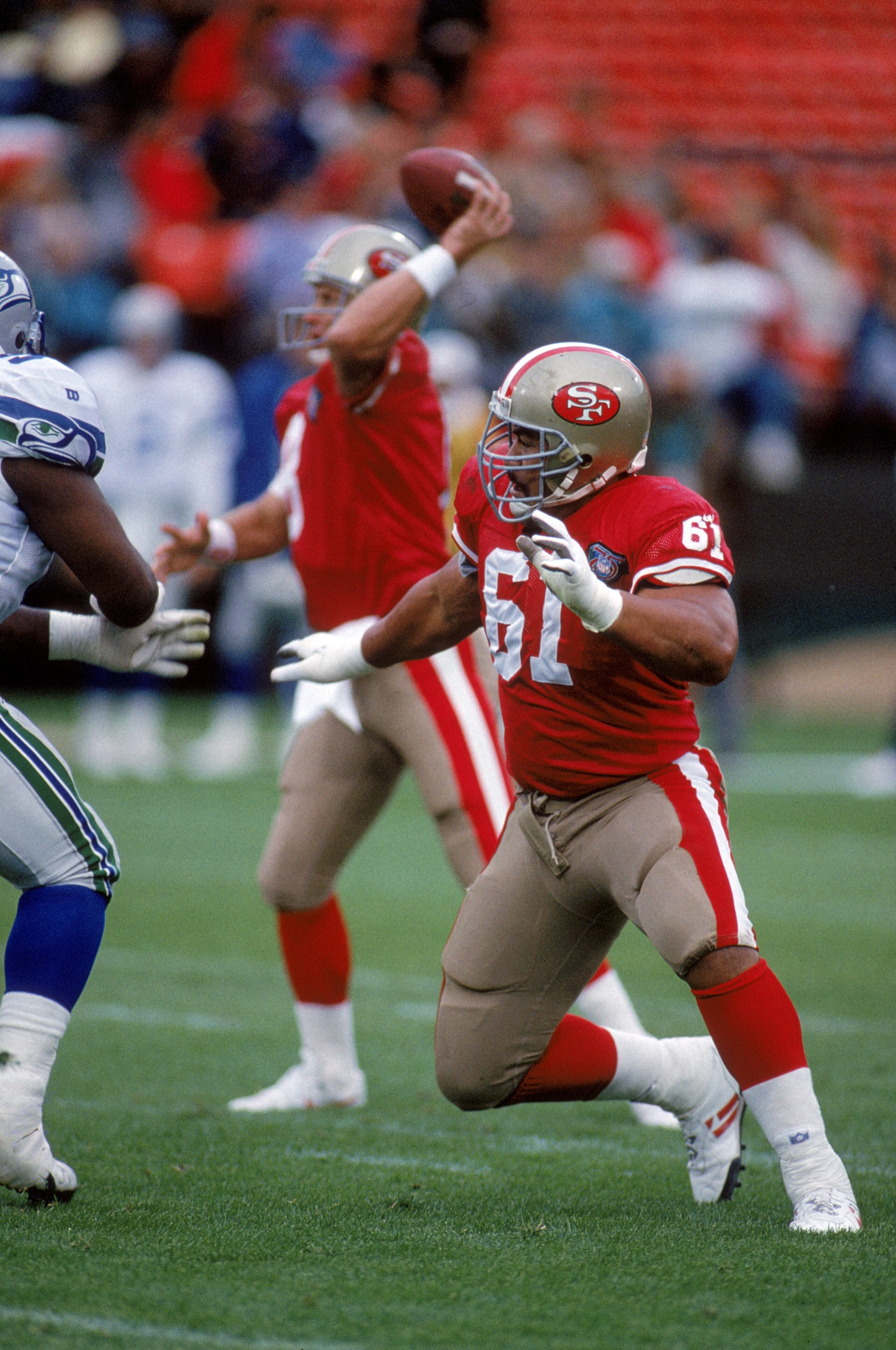 SAN FRANCISCO - AUGUST 26:  Offensive guard Jesse Sapolu #61 of the San Francisco 49ers blocks during a preseason game against the Seattle Seahawks at Candlestick Park on August 26, 1994 in San Francisco, California.  The 49ers won 13-9.  (Photo by George
