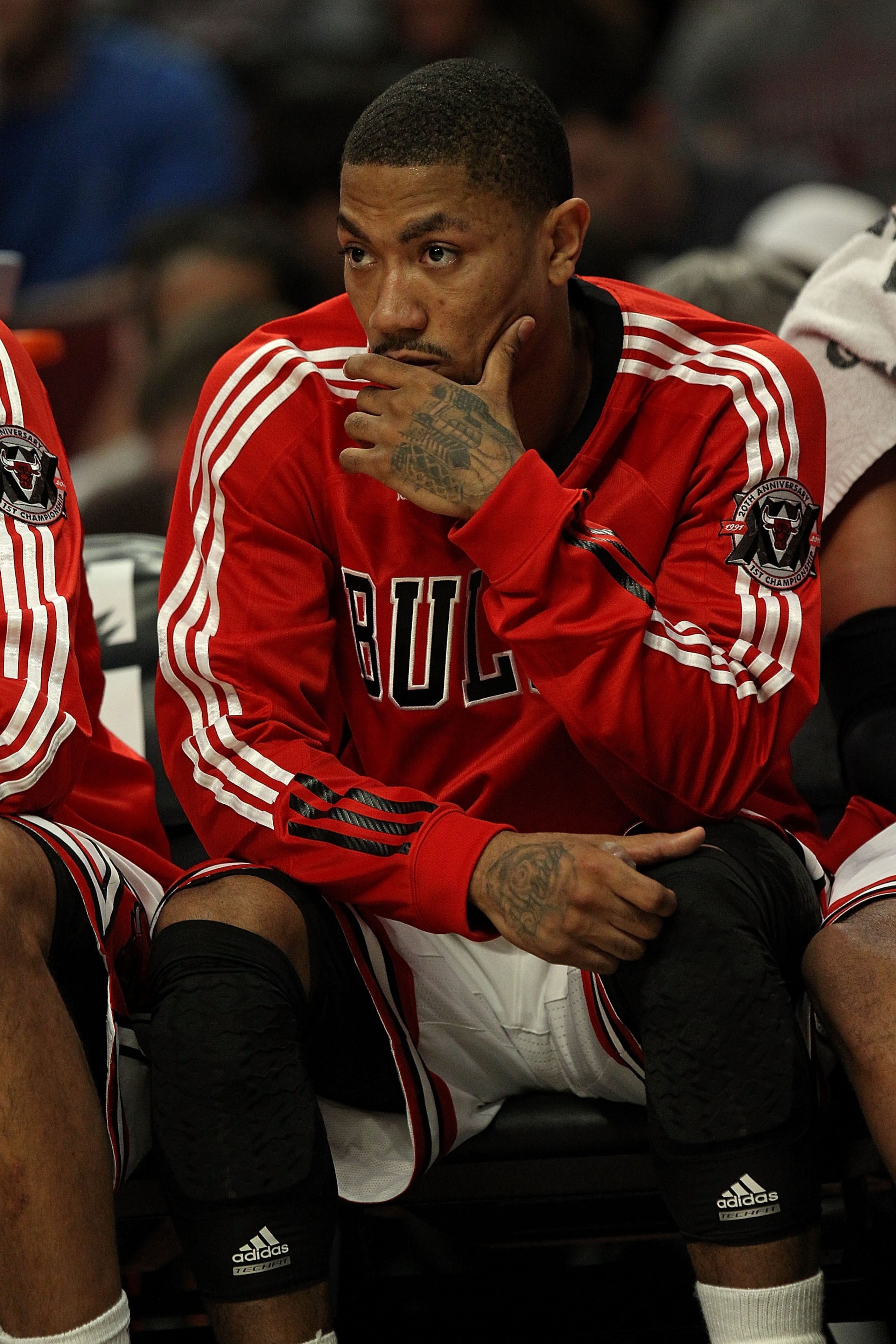 CHICAGO, IL - MARCH 25: Derrick Rose #1 of the Chicago Bulls watches from the bench as his teammates take on the Memphis Grizzlies at the United Center on March 25, 2011 in Chicago, Illinois. The Bulls defeated the Grizzlies 99-96. NOTE TO USER: User expr