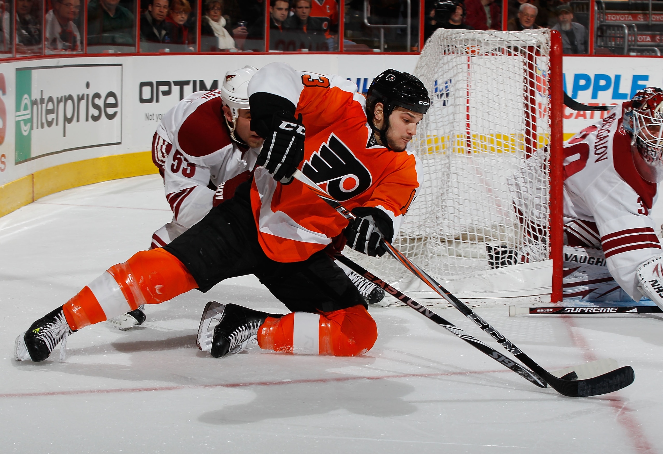 PHILADELPHIA - FEBRUARY 22:  Daniel Carcillo #13 of the Philadelphia Flyers falls to the ice playing the puck against Derek Morris #53 of the Phoenix Coyotes on February 22, 2011 at the Wells Fargo Center in Philadelphia, Pennsylvania. Coyotes defeat the