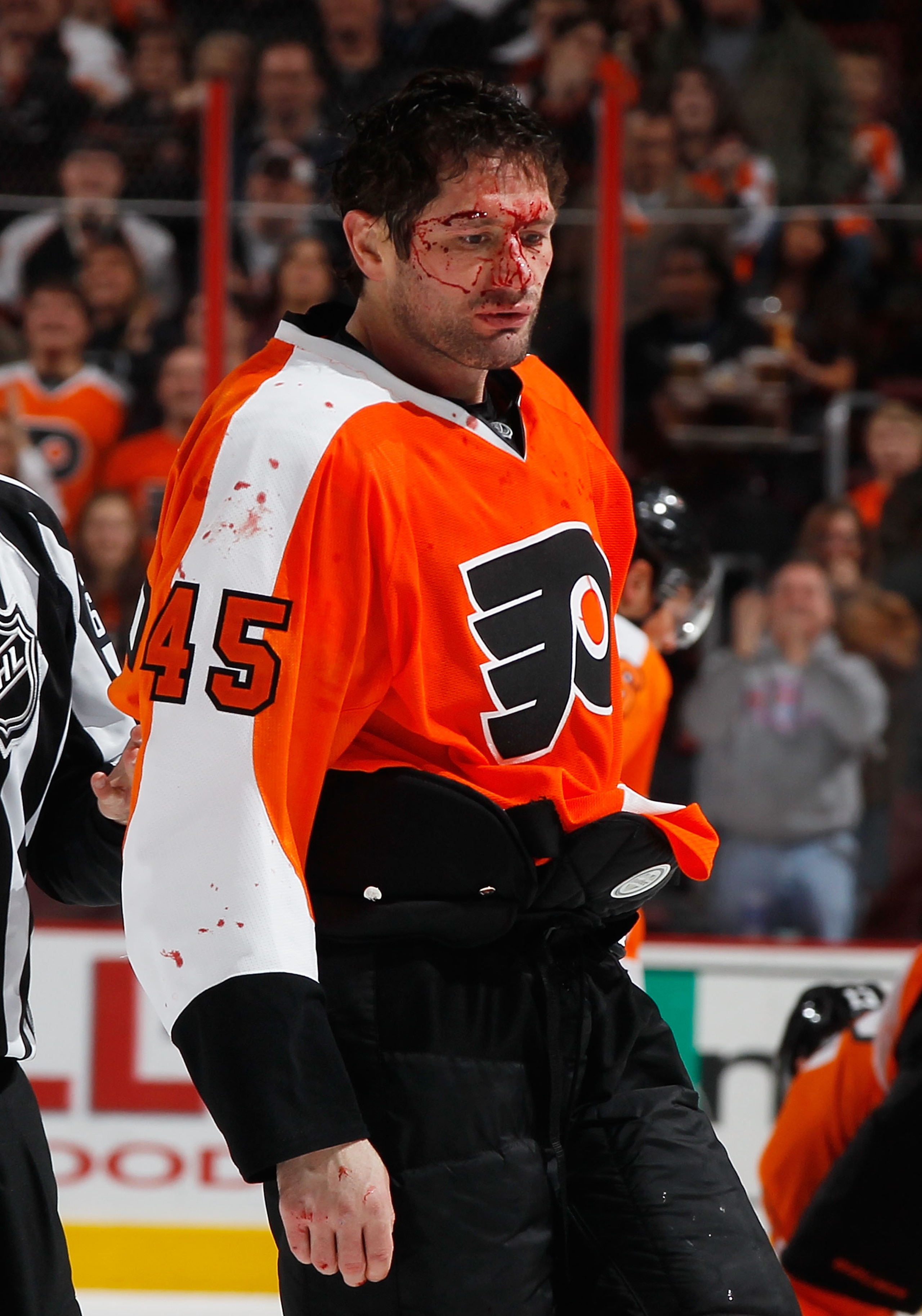 PHILADELPHIA - FEBRUARY 22:  Jody Shelley #45 of the Philadelphia Flyers is escorted off the ice after fighting Nolan Yonkman (not pictured) of the Phoenix Coyotes during the second period on February 22, 2011 at the Wells Fargo Center in Philadelphia, Pe