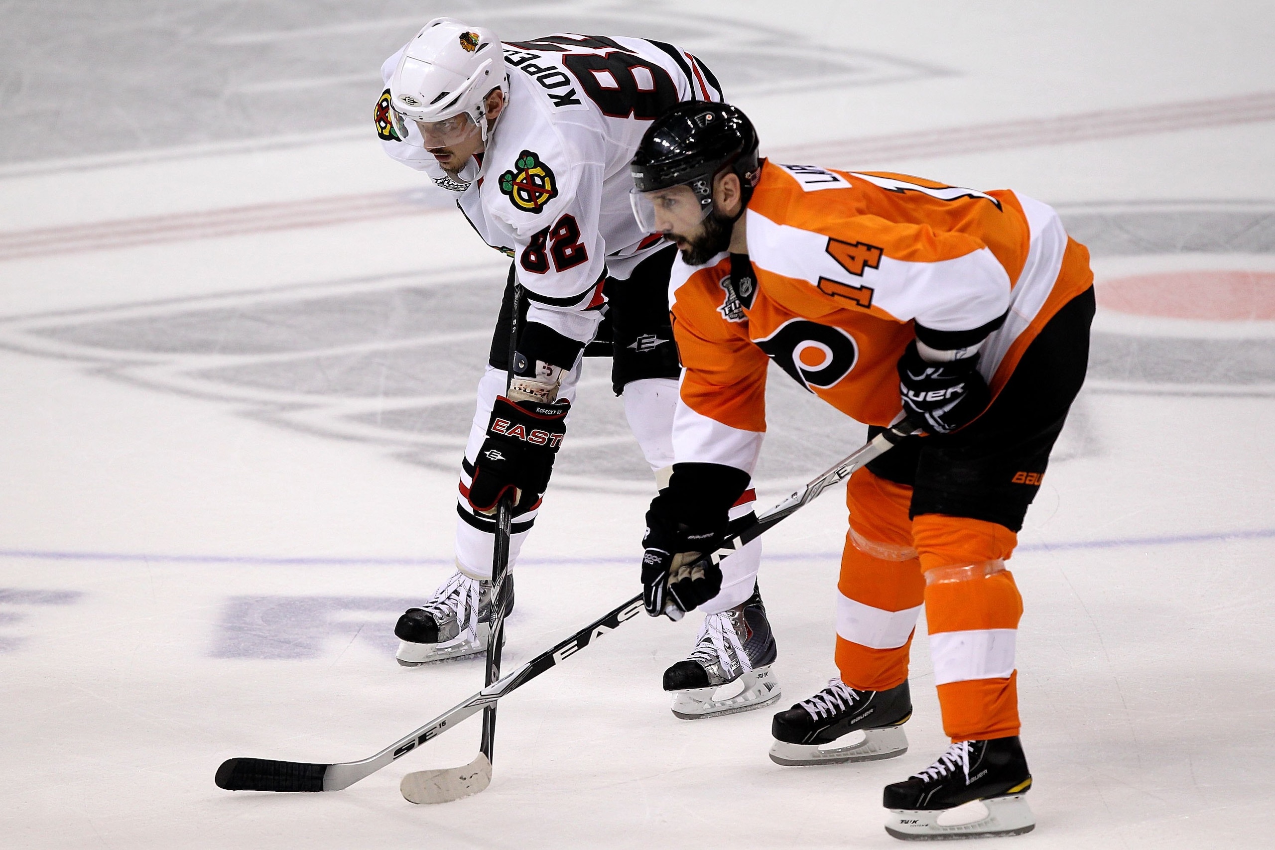 PHILADELPHIA - JUNE 04:  Tomas Kopecky #82 of the Chicago Blackhawks faces off against Ian Laperriere #14 of the Philadelphia Flyers in Game Four of the 2010 NHL Stanley Cup Final at Wachovia Center on June 4, 2010 in Philadelphia, Pennsylvania.  (Photo b