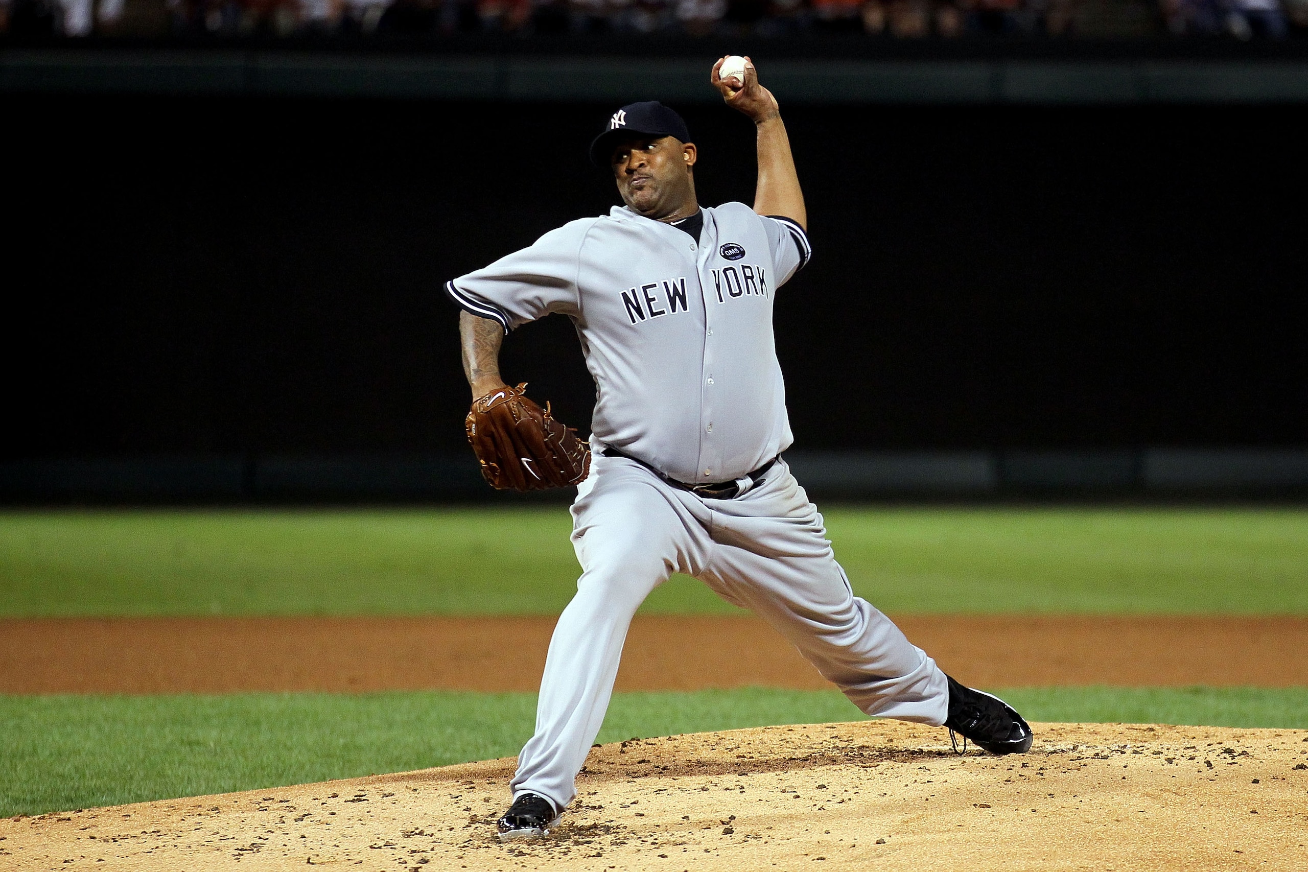 ARLINGTON, TX - OCTOBER 15:  CC Sabithia #52 of the New York Yankees throws a pitch against the Texas Rangers in Game One of the ALCS during the 2010 MLB Playoffs at Rangers Ballpark in Arlington on October 15, 2010 in Arlington, Texas.  (Photo by Stephen