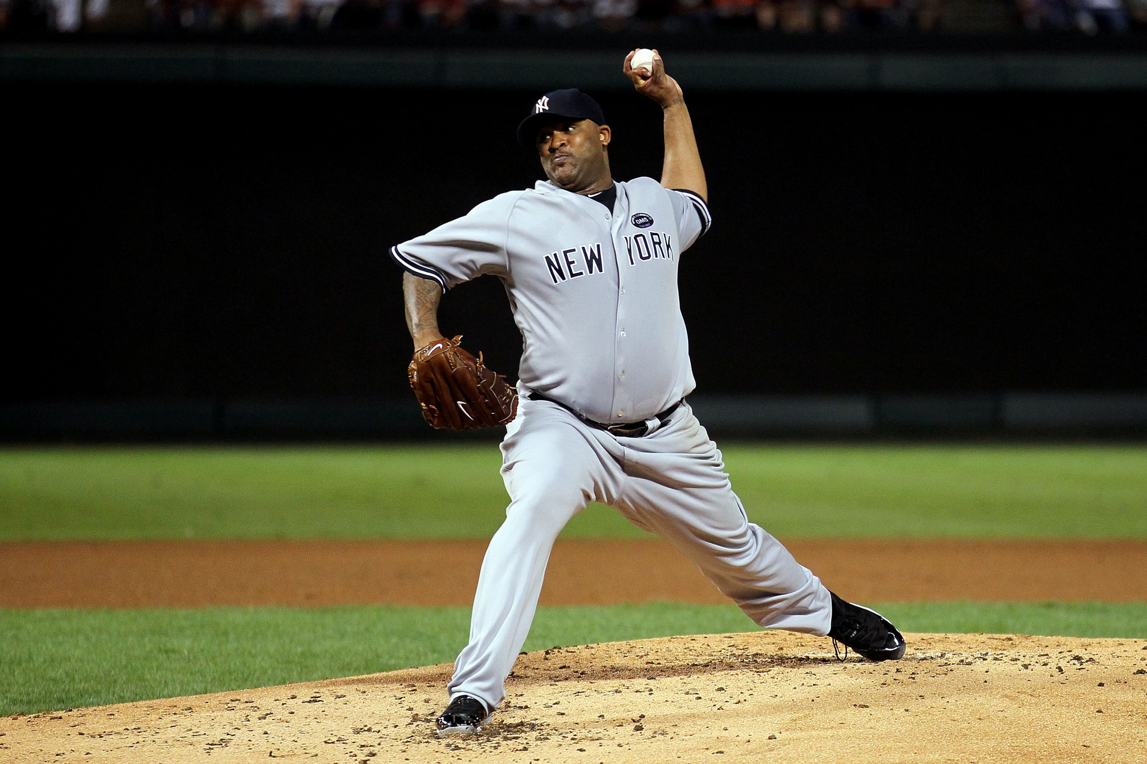 ARLINGTON, TX - OCTOBER 15:  CC Sabithia #52 of the New York Yankees throws a pitch against the Texas Rangers in Game One of the ALCS during the 2010 MLB Playoffs at Rangers Ballpark in Arlington on October 15, 2010 in Arlington, Texas.  (Photo by Stephen