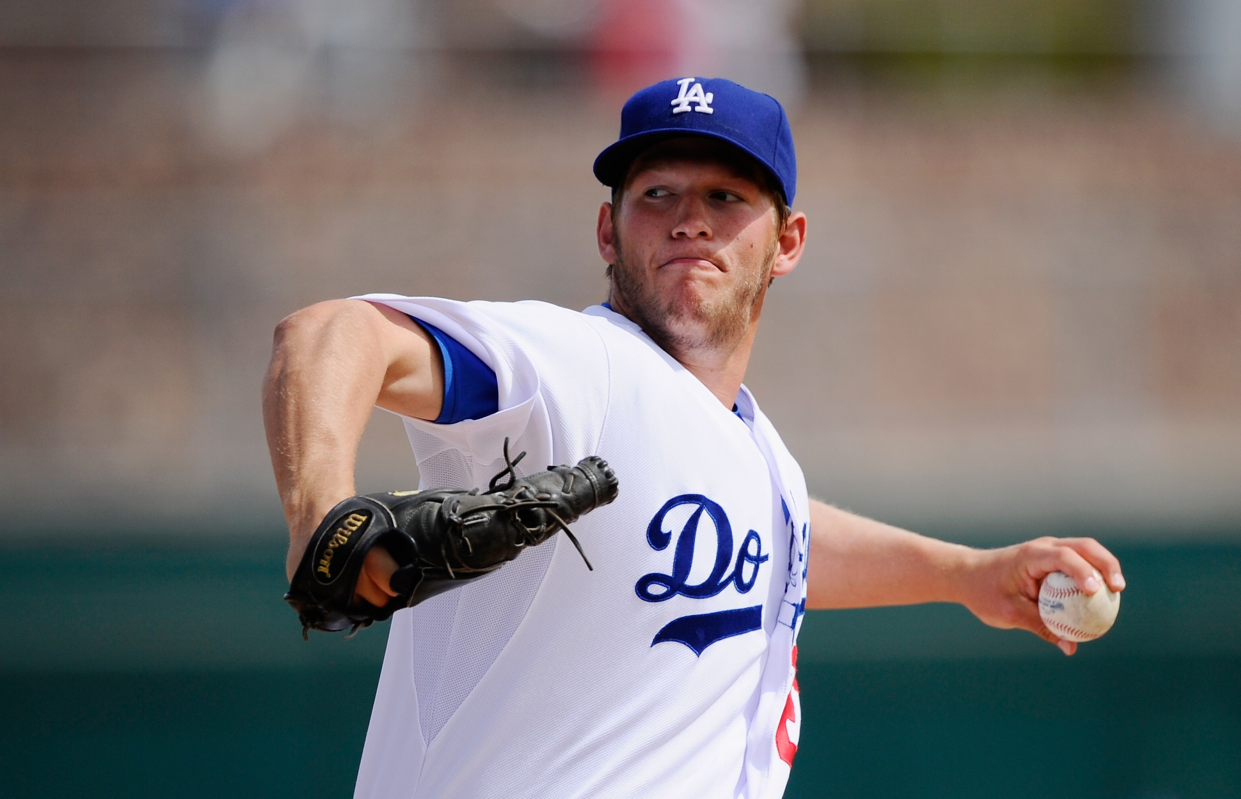 GLENDALE, AZ - MARCH 15:  Pitcher Clayton Kershaw #22 of the Los Angeles Dodgers throws a pitch against Texas Rangers during the spring training baseball game at Camelback Ranch on March 15, 2011 in Glendale, Arizona.  (Photo by Kevork Djansezian/Getty Im