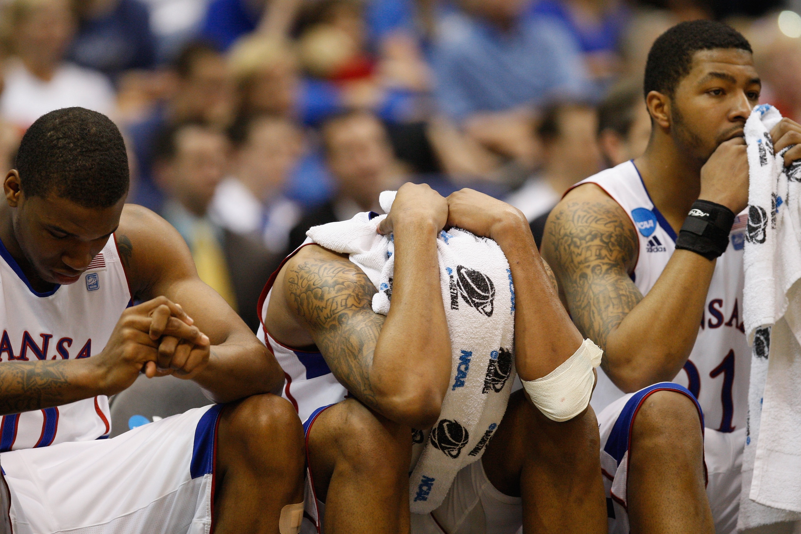 SAN ANTONIO, TX - MARCH 27:  (L-R) Thomas Robinson #0, Marcus Morris #22 and Markieff Morris #21 of the Kansas Jayhawks react during the southwest regional final of the 2011 NCAA men's basketball tournament at the Alamodome on March 27, 2011 in San Antoni