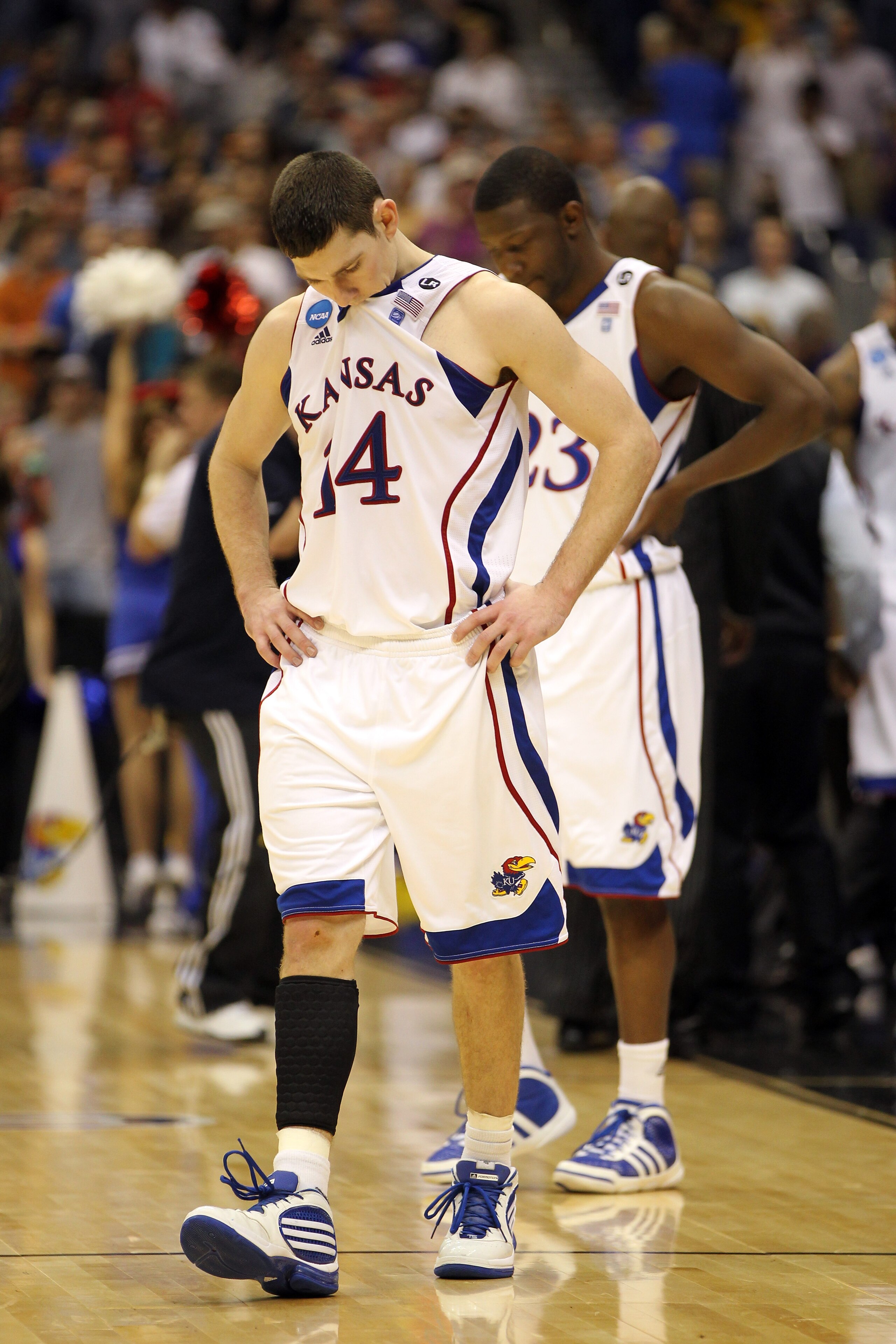 SAN ANTONIO, TX - MARCH 27:  Tyrel Reed #14 and Mario Little #23 of the Kansas Jayhawks react after the southwest regional final of the 2011 NCAA men's basketball tournament against the Virginia Commonwealth Rams at the Alamodome on March 27, 2011 in San