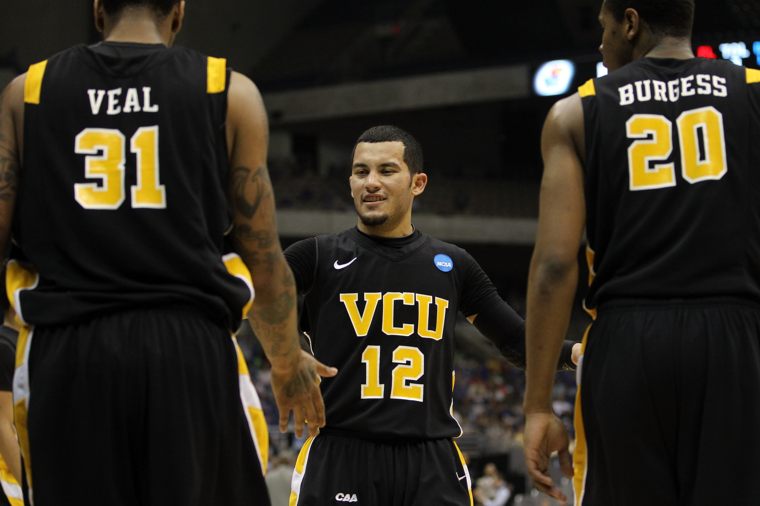 SAN ANTONIO, TX - MARCH 27:  (L-R) Toby Veal #31, Joey Rodriguez #12 and Bradford Burgess #20 of the Virginia Commonwealth Rams react during the southwest regional final of the 2011 NCAA men's basketball tournament against the Kansas Jayhawks at the Alamo