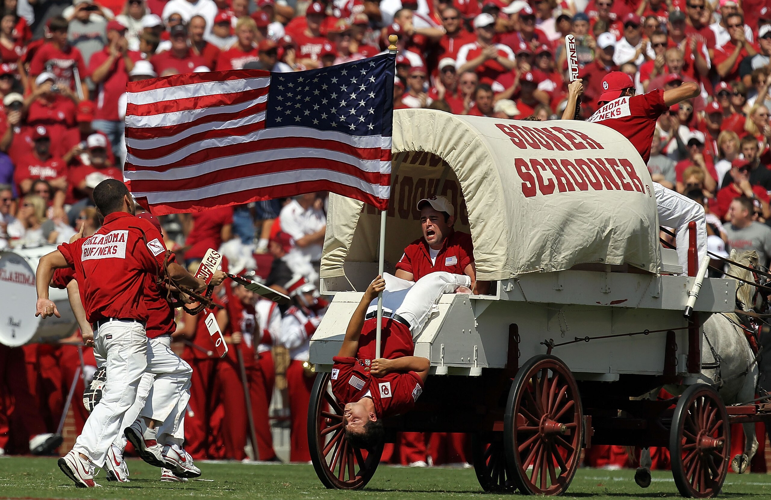 NORMAN, OK - SEPTEMBER 11:  The Oklahoma Sooner Schooner carries the American flag on the anniversary of September 11  at Gaylord Family Oklahoma Memorial Stadium on September 11, 2010 in Norman, Oklahoma.  (Photo by Ronald Martinez/Getty Images)