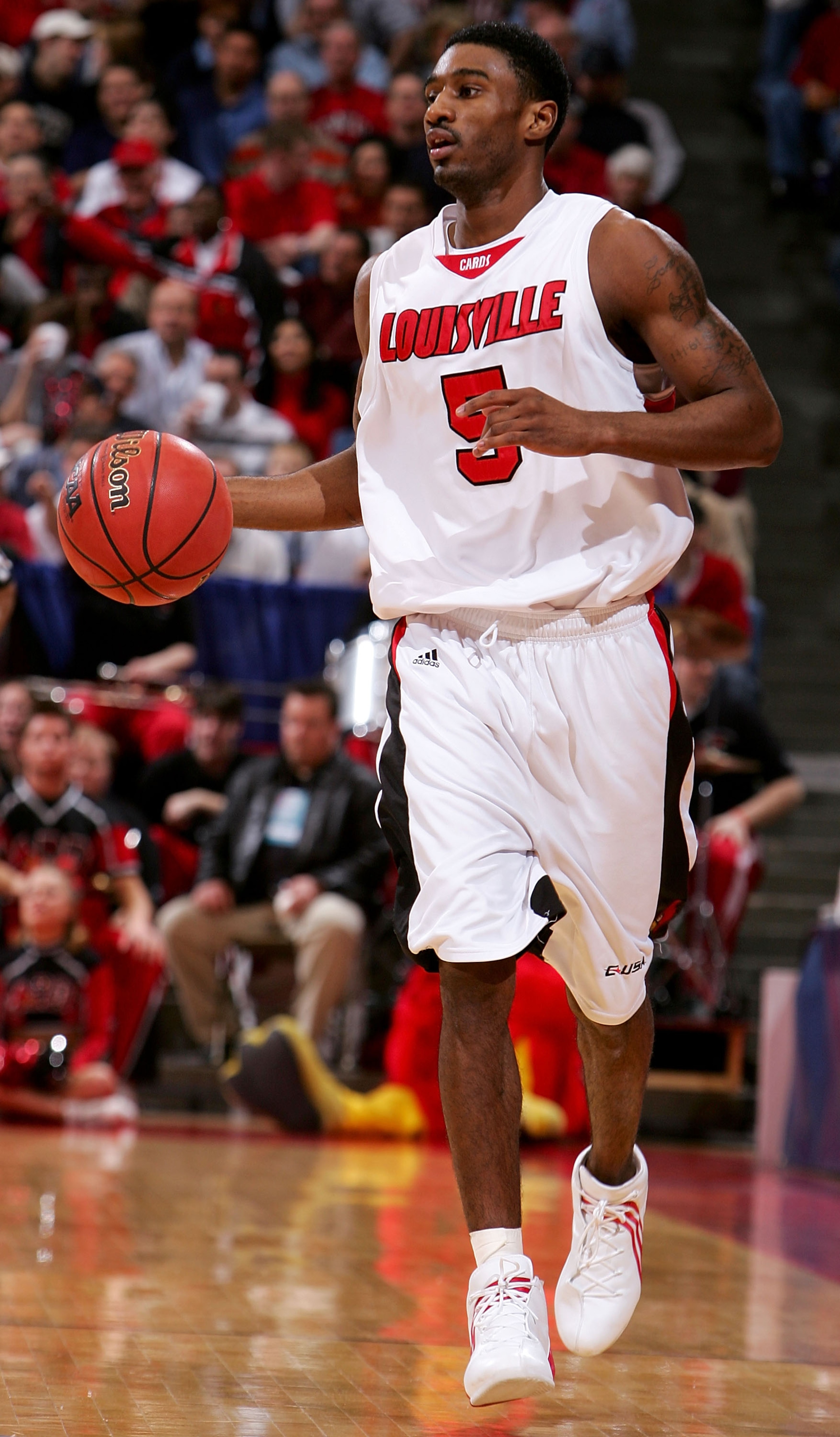 ALBUQUERQUE, NM - MARCH 26:  Taquan Dean #5 of the Louisville Cardinals moves the ball upcourt in the game against the West Virginia Mountaineers during the Elite 8 game of the NCAA Division I Men's Basketball Tournament on March 26, 2005 at The Pit in Al
