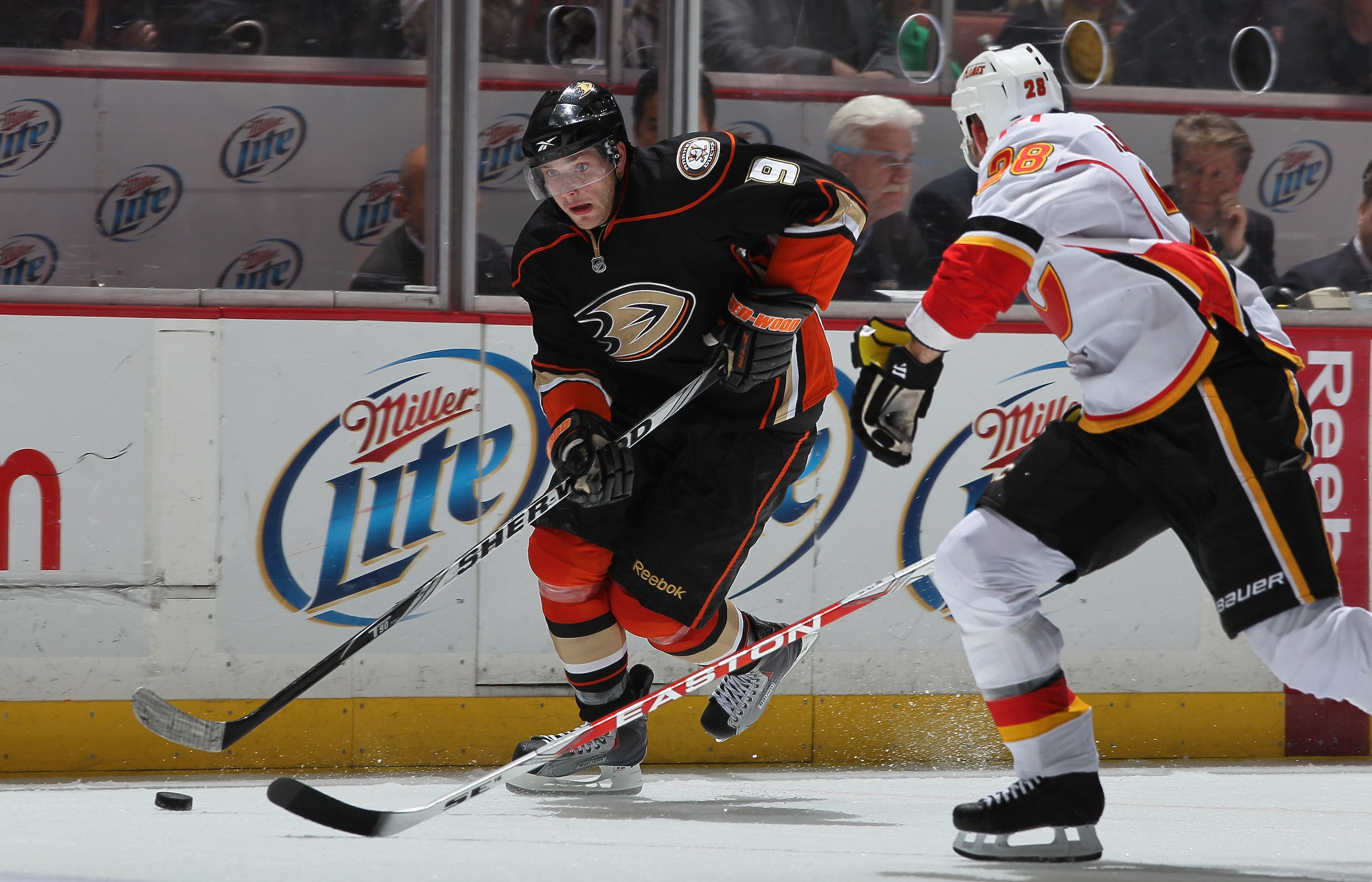 ANAHEIM, CA - DECEMBER 10:  Bobby Ryan #9 of the Anaheim Ducks is pursued by Robyn Regehr #28 of the Calgary Flames for the puck at the Honda Center on December 10, 2010 in Anaheim, California.  (Photo by Jeff Gross/Getty Images)