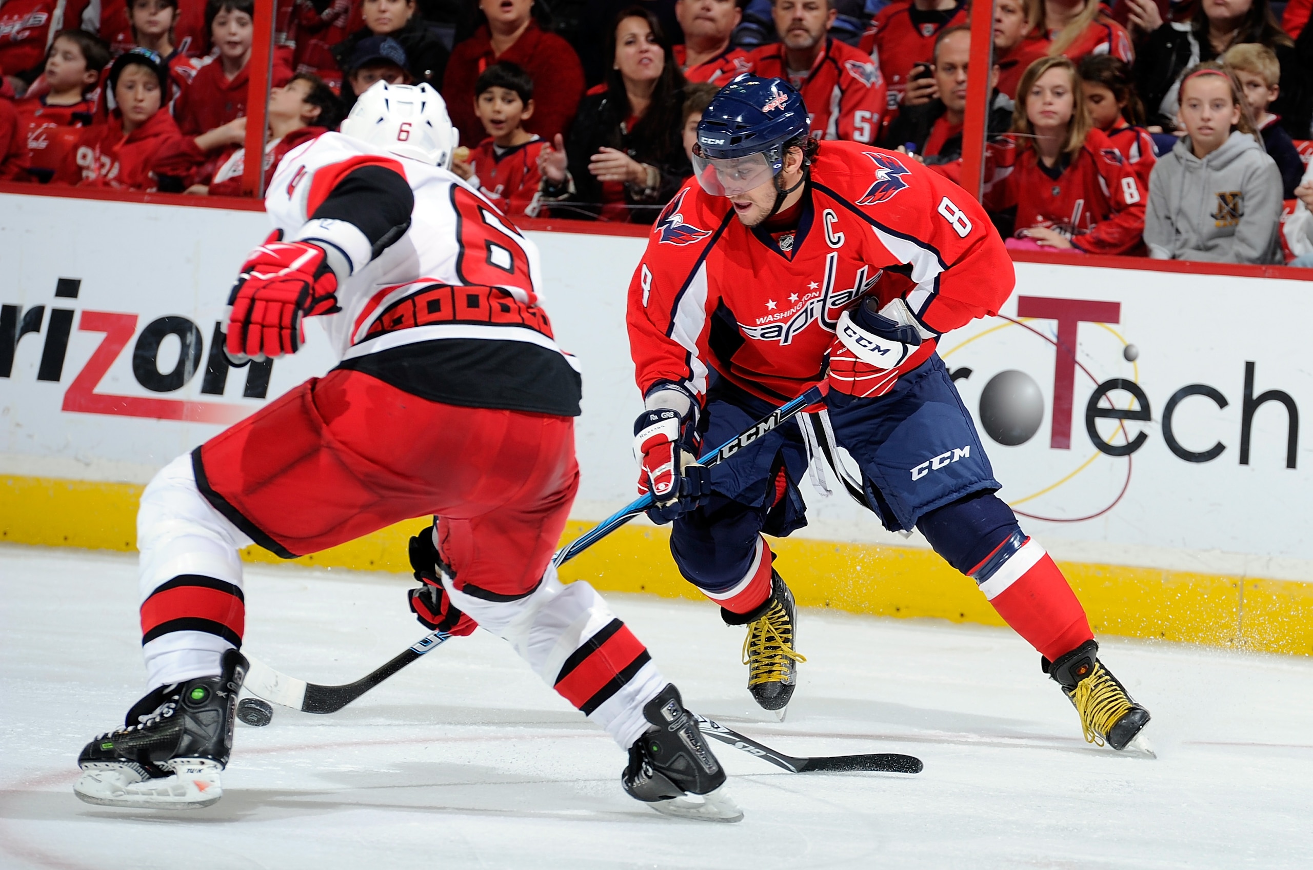WASHINGTON - NOVEMBER 28:  Alex Ovechkin #8 of the Washington Capitals brings the puck down the ice against Tim Gleason #6 of the Carolina Hurricanes at the Verizon Center on November 28, 2010 in Washington, DC. The Capitals won the game 3-2.  (Photo by G