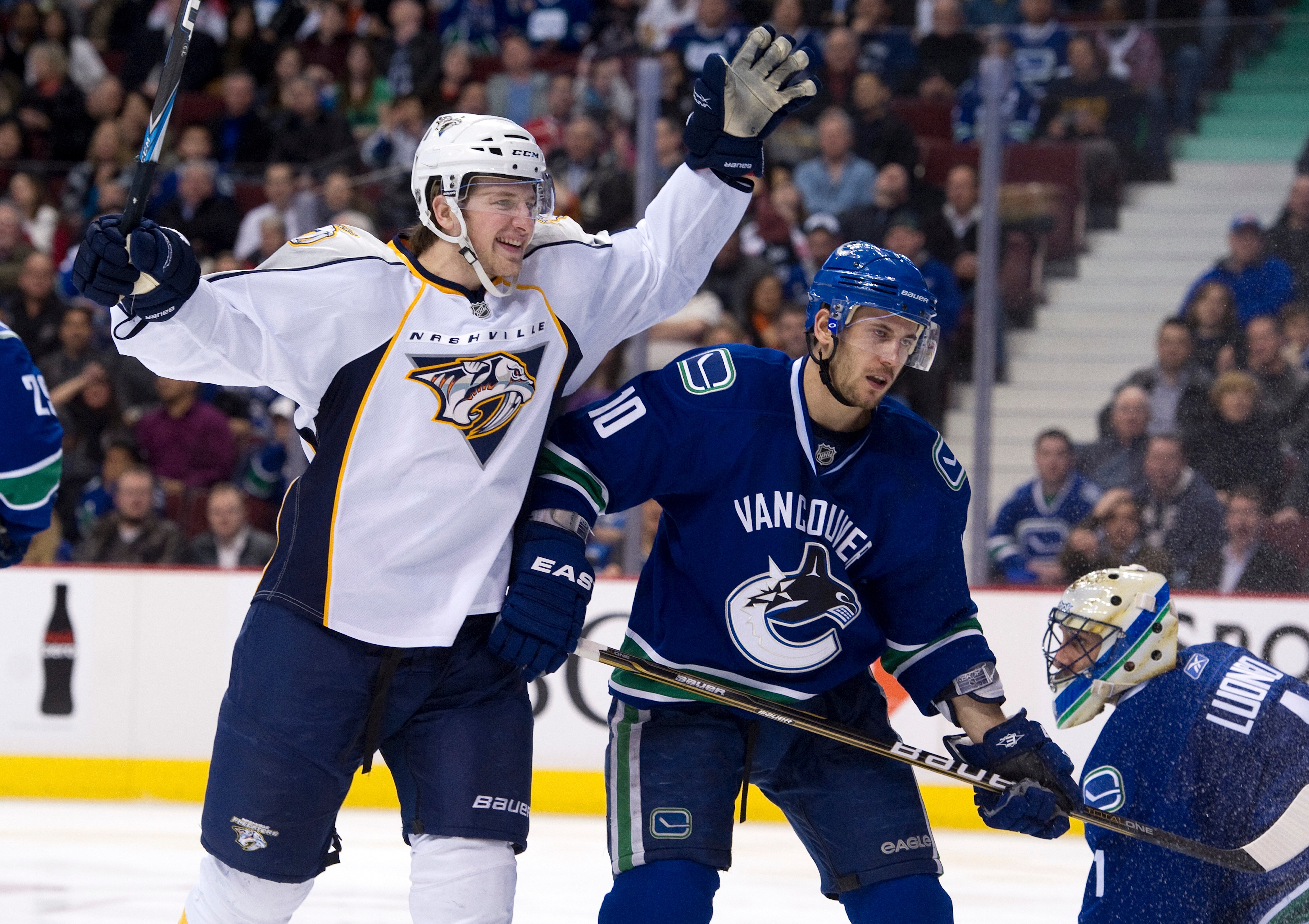 VANCOUVER, CANADA - MARCH 3: Blake Geoffrion #5 of the Nashville Predators celebrates after scoring what proved to be the game winning goal against goalie Roberto Luongo #1 of the Vancouver Canucks as Jeff Tambellini #10 skates past during the third perio