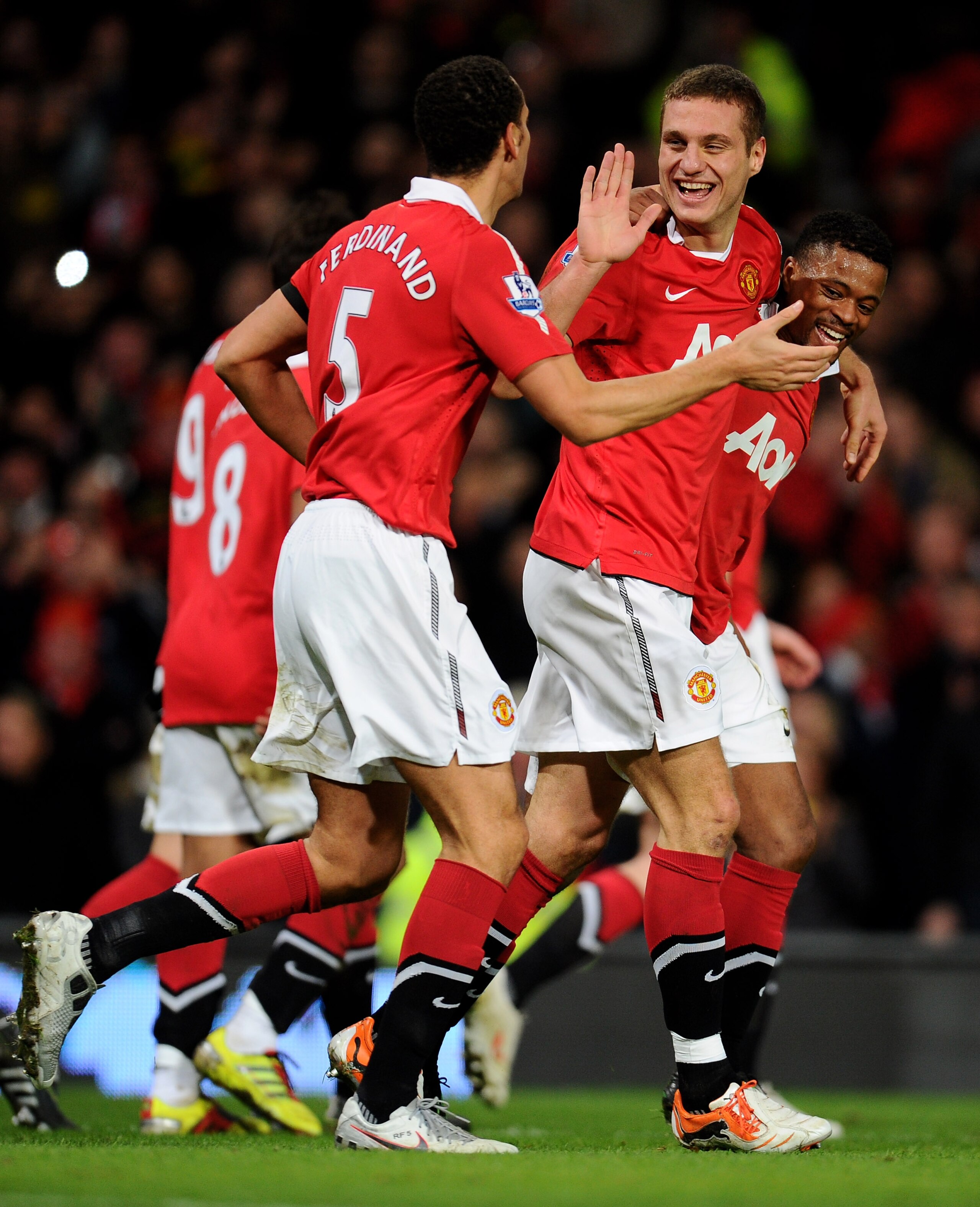 MANCHESTER, ENGLAND - FEBRUARY 01:  Nemanja Vidic of Manchester United celebrates scoring his team's third goal with team mates Rio Ferdinand and Patrice Evra (R) during the Barclays Premier League match between Manchester United and Aston Villa at Old Tr
