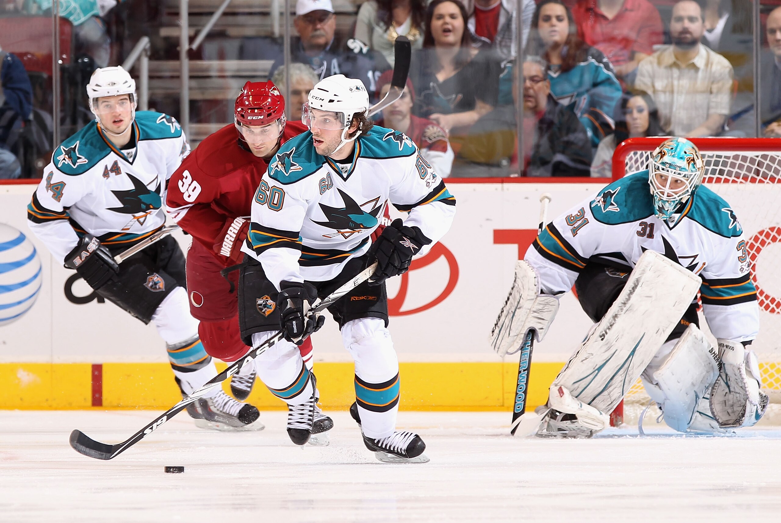 GLENDALE, AZ - MARCH 26:  Jason Demers #60 of the San Jose Sharks skates with the puck during the NHL game against the Phoenix Coyotes at Jobing.com Arena on March 26, 2011 in Glendale, Arizona. The Sharks defeated the Coyotes 4-1.  (Photo by Christian Pe