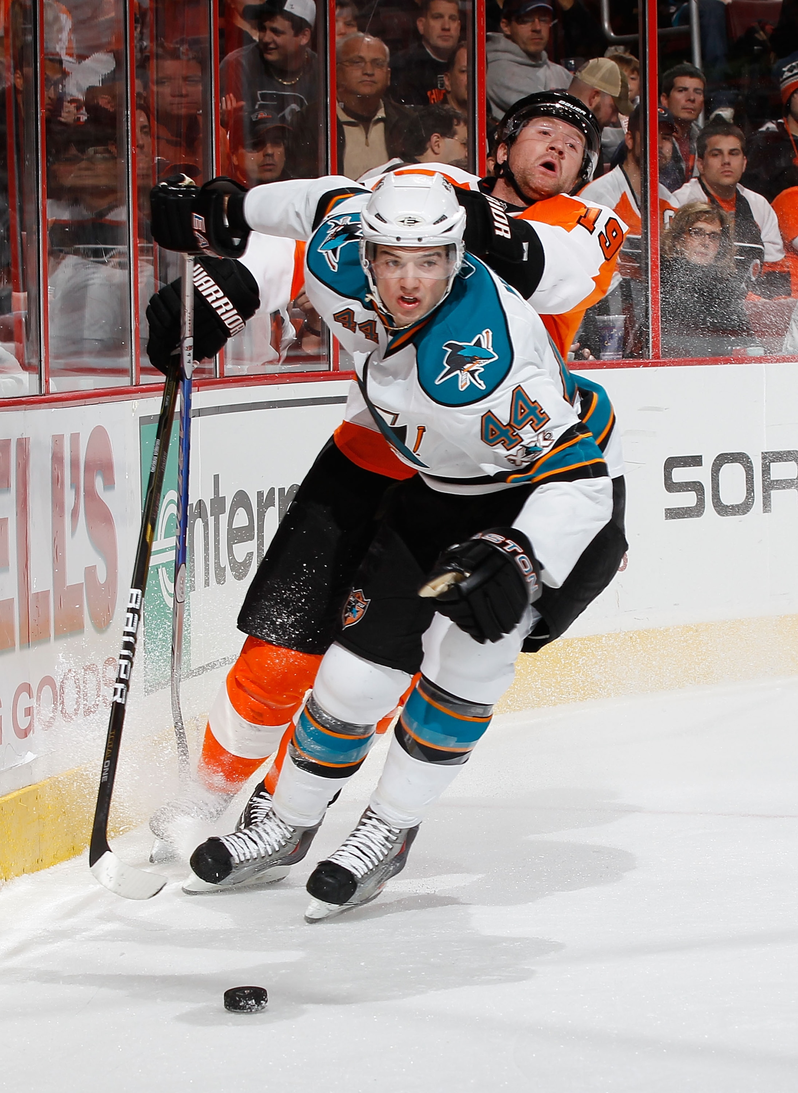 PHILADELPHIA - DECEMBER 08:  Scott Hartnell #19 of the Philadelphia Flyers and Marc-Edouard Vlasic #44 of the San Jose Sharks battle for the puck behind the net on December 8, 2010 at the Wells Fargo Center in Philadelphia, Pennsylvania. Sharks defeat the