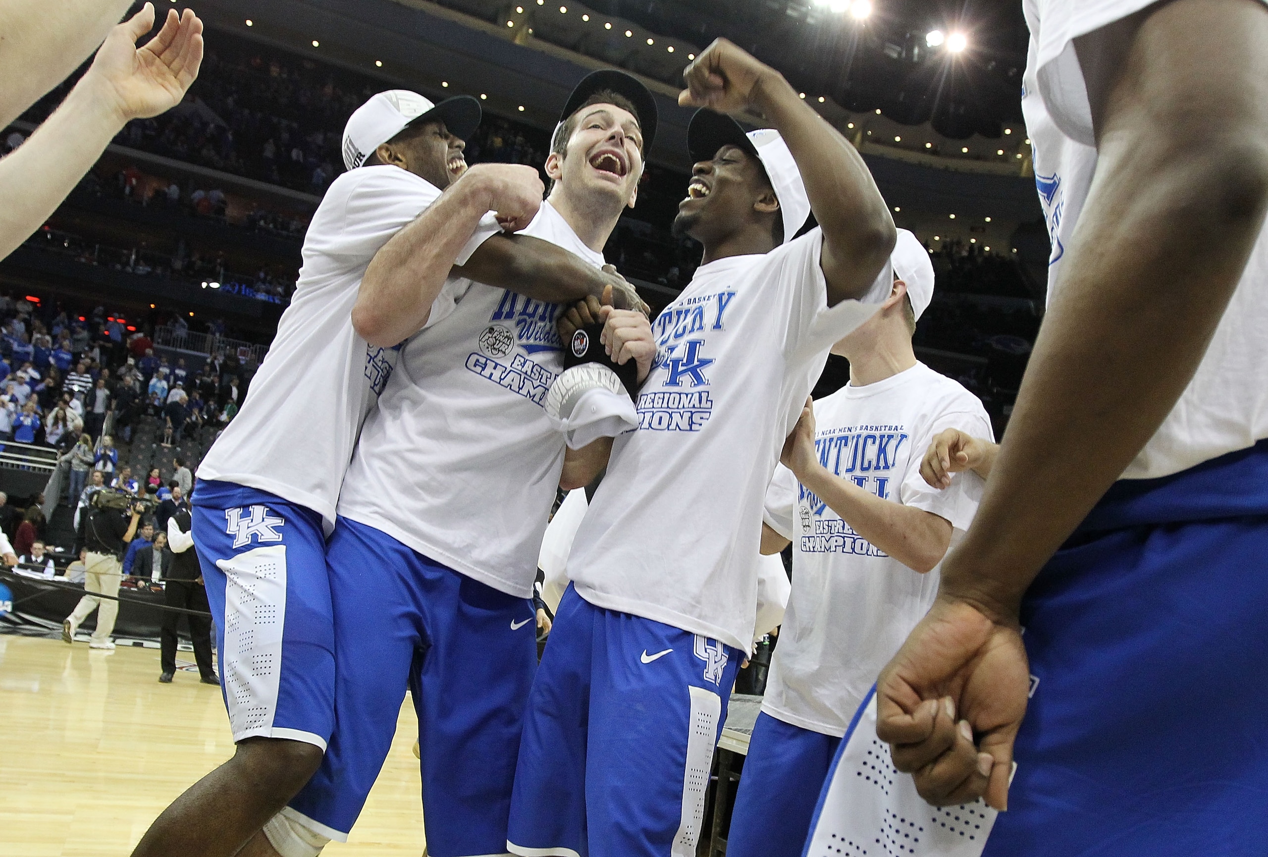 NEWARK, NJ - MARCH 27:  Josh Harrellson #55 and Stacey Poole Jr. #2 of the Kentucky Wildcats celebrates after defeating the North Carolina Tar Heels during the east regional final of the 2011 NCAA men's basketball tournament at Prudential Center on March