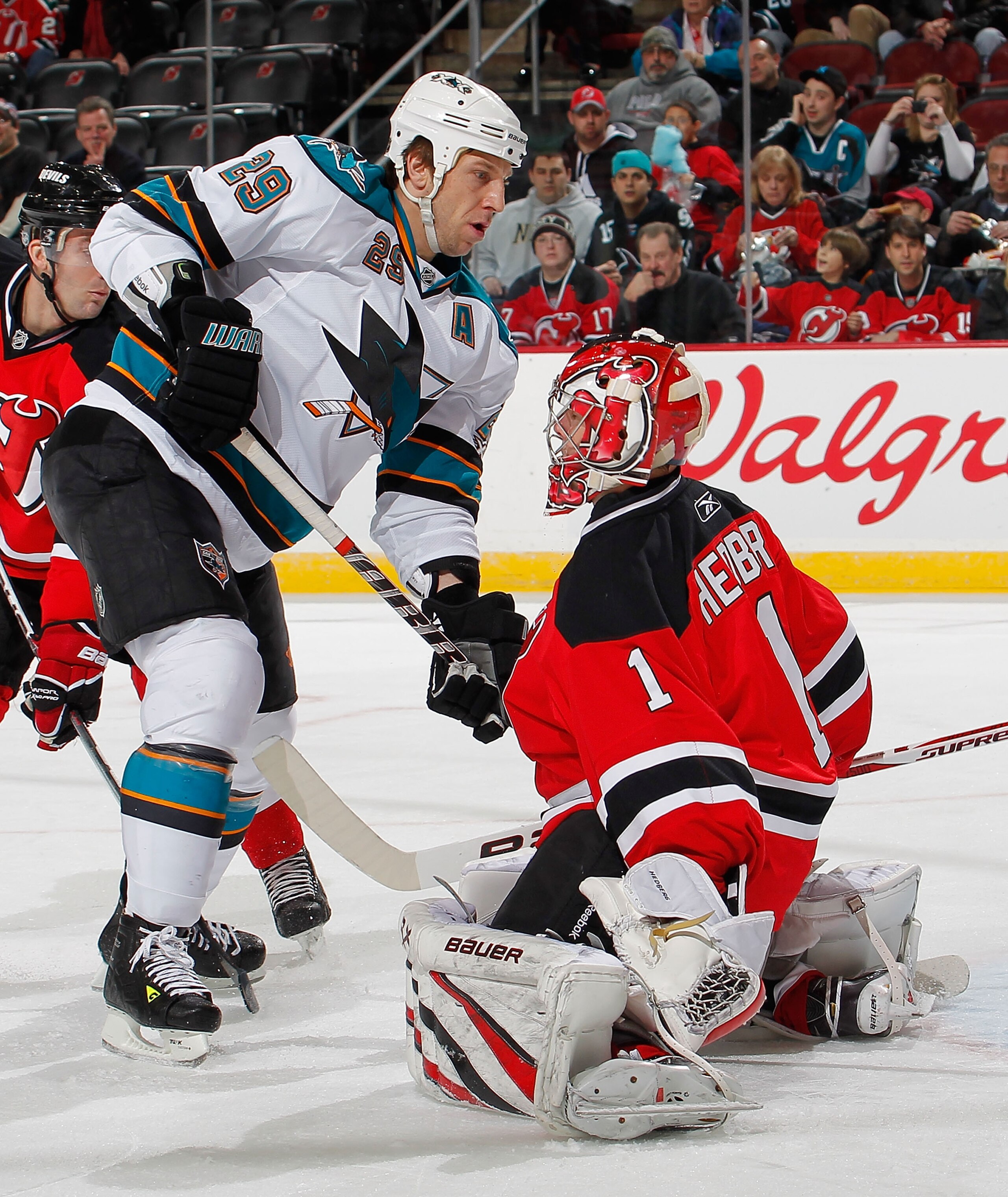 NEWARK, NJ - FEBRUARY 11:  Ryane Clowe #29 of the San Jose Sharks is stopped on this scoring attempt by Goalie Johan Hedberg #1 of the New Jersey Devils during the first period of an NHL hockey game on February 11, 2011 at the Prudential Center in Newark,