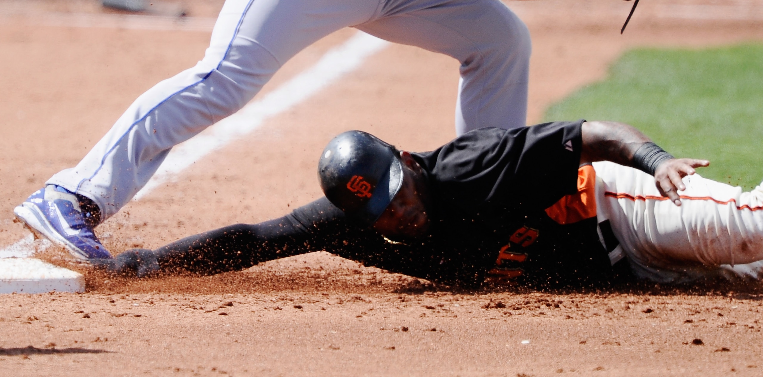 SCOTTSDALE, AZ - MARCH 18:  Pablo Sandoval # 48 of the San Francisco Giants is doubled up by first baseman Jame Loney #7 of the Los Angeles Dodgers after a throw from short stop Rafaell Furcal #15 during the second inning of the spring training baseball g