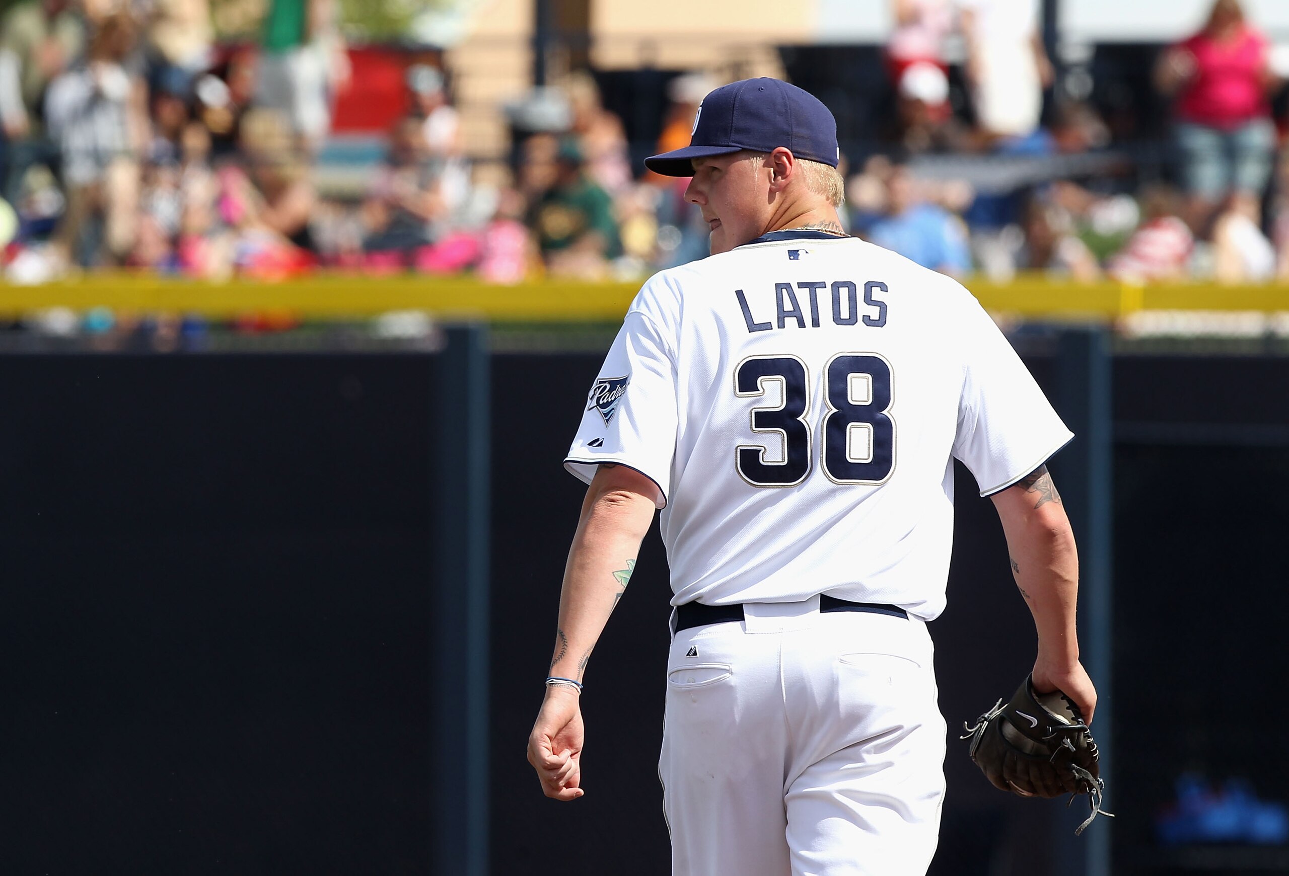 PEORIA, AZ - MARCH 06:  Starting pitcher Mat Latos #38 of the San Diego Padres walks off the field after being removed from the spring training game against the Oakland Athletics at Peoria Stadium on March 6, 2011 in Peoria, Arizona.  (Photo by Christian