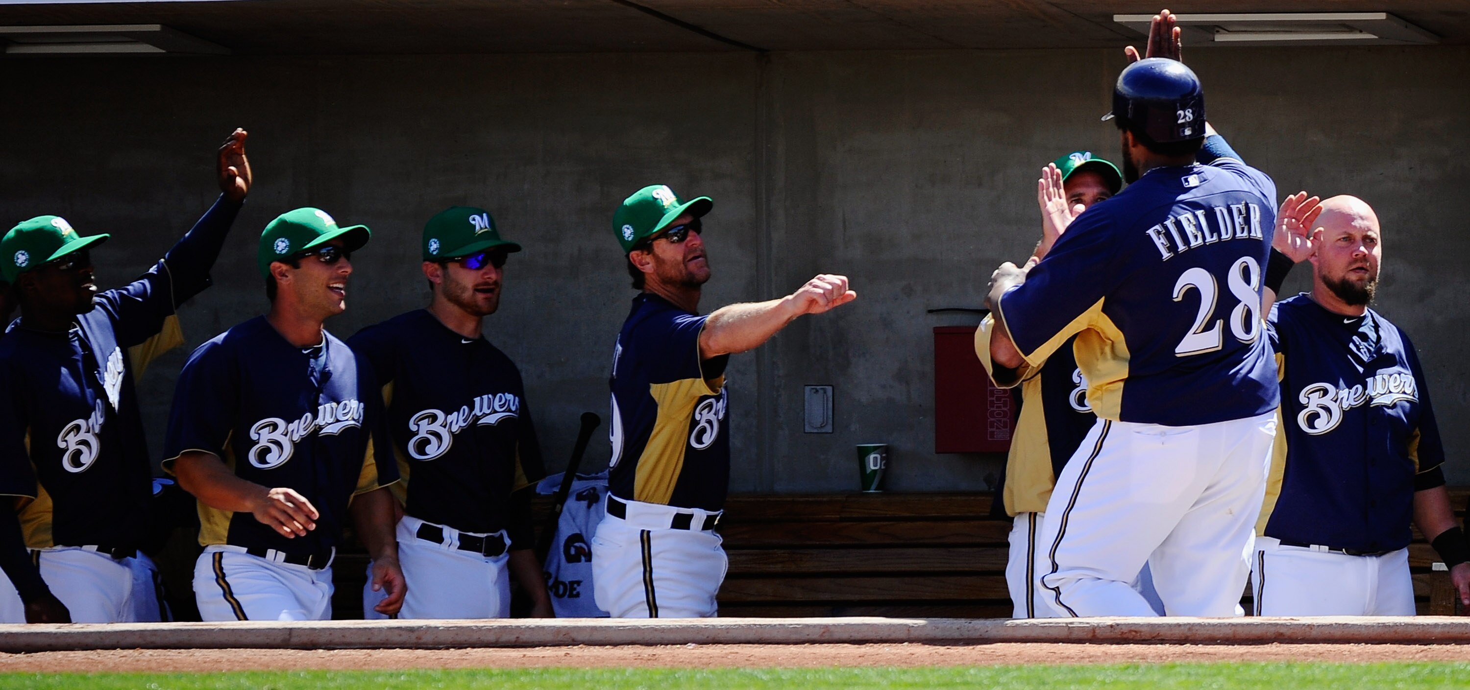 PHOENIX, AZ - MARCH 17:  Prince Fielder #28 of the Milwaukee Brewers is congratulated by teammates after scoring on a two-run double by Jeremy Reed #62 against pitcher Edwin Jackson #33 of the Chicago White Sox during the first inning of the spring traini