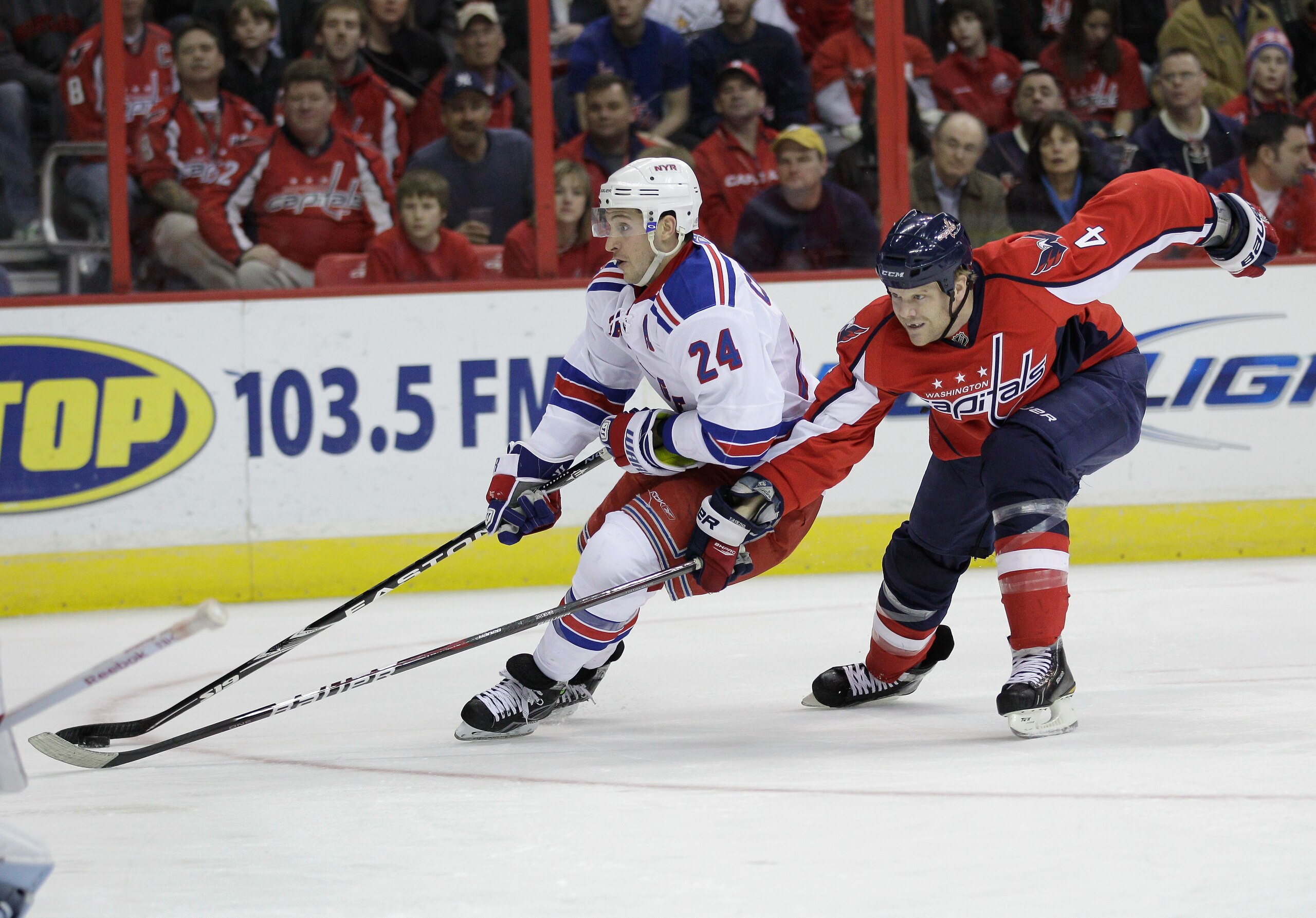 WASHINGTON, DC - FEBRUARY 25:  Ryan Callahan #24 of the New York Rangers stakes with the puck in front of John Erskine #4 of the Washington Capitals duirng the second period at the Verizon Center on February 25, 2011 in Washington, DC.  (Photo by Rob Carr