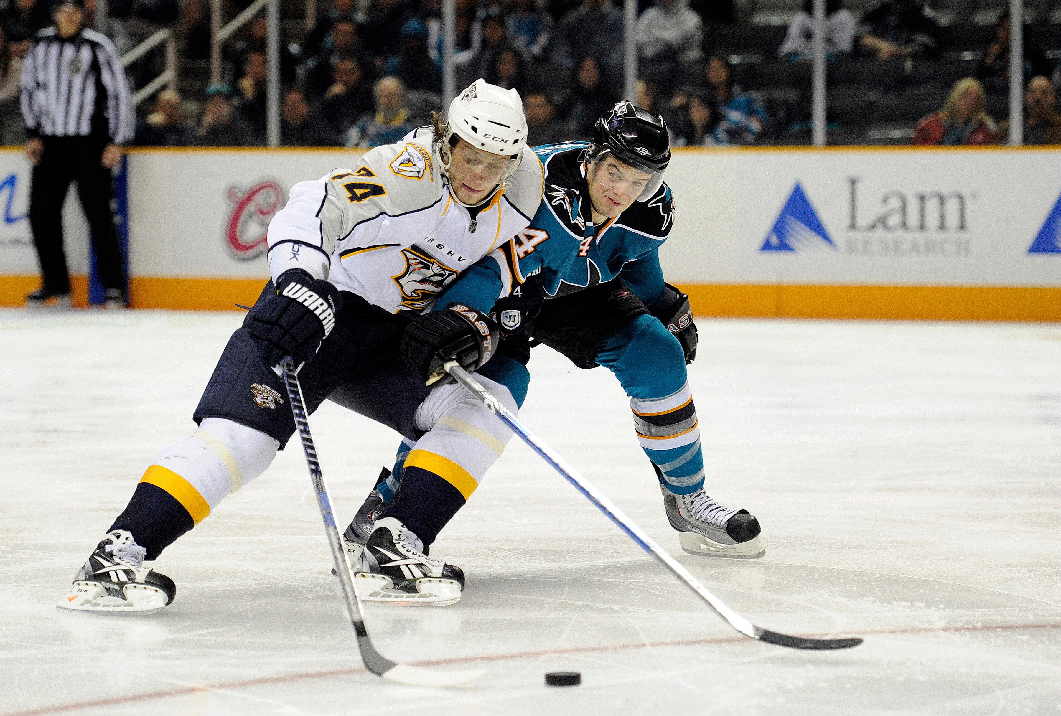 SAN JOSE, CA - MARCH 8: Sergei Kostitsyn #74 of the Nashville Predators on a break away has the puck slapped away by Marc-Edouard Vlasic #44 of the San Jose Sharks in third period of an NHL hockey game at the HP Pavilion on March 8, 2011 in San Jose, Cali
