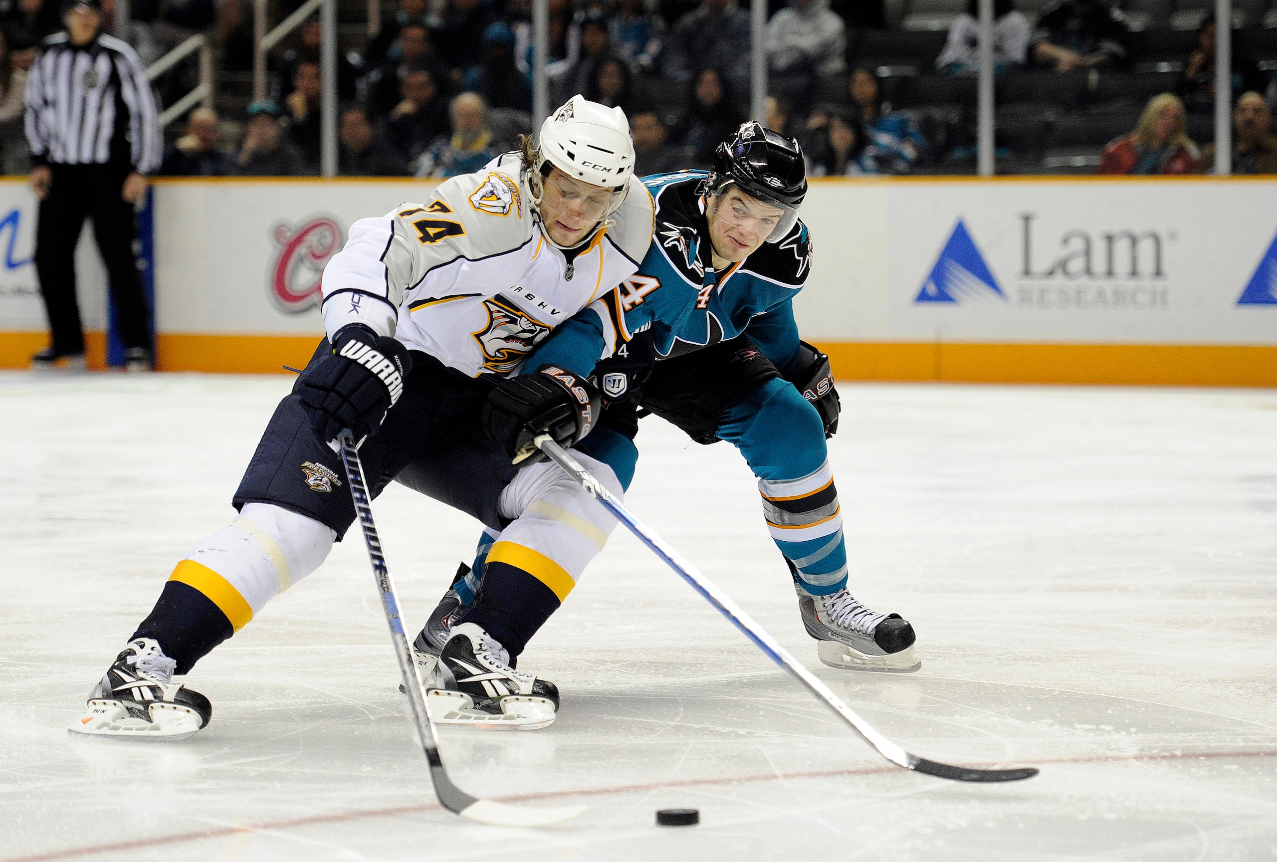 SAN JOSE, CA - MARCH 8: Sergei Kostitsyn #74 of the Nashville Predators on a break away has the puck slapped away by Marc-Edouard Vlasic #44 of the San Jose Sharks in third period of an NHL hockey game at the HP Pavilion on March 8, 2011 in San Jose, Cali