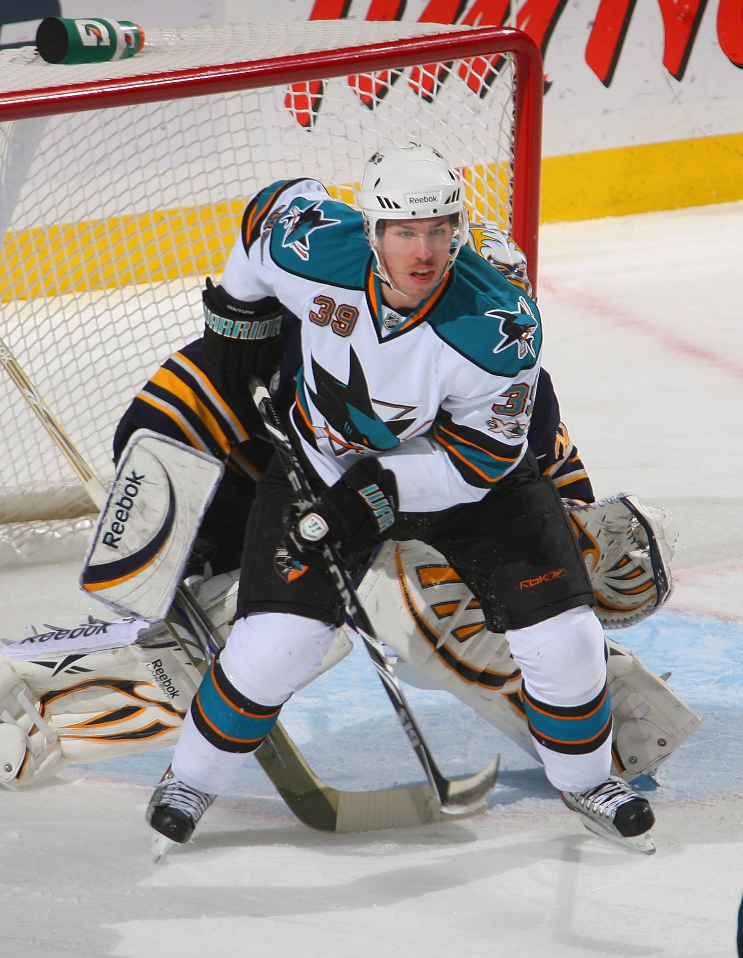 BUFFALO, NY - DECEMBER 09: Logan Couture #39 of the San Jose Sharks stands in front of Ryan Miller #30 of the Buffalo Sabres at HSBC Arena on December 9, 2010 in Buffalo, New York.  (Photo by Rick Stewart/Getty Images)