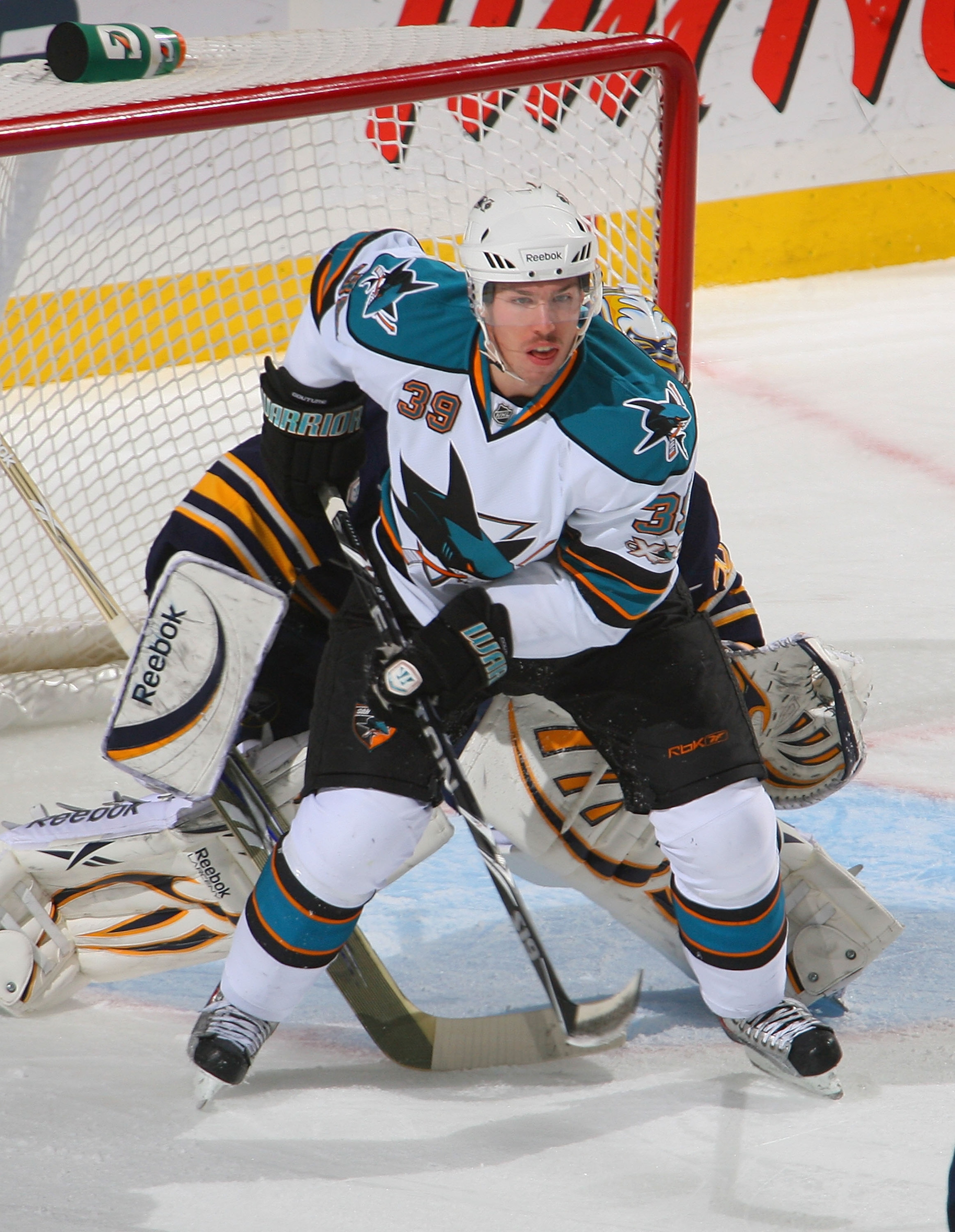 BUFFALO, NY - DECEMBER 09: Logan Couture #39 of the San Jose Sharks stands in front of Ryan Miller #30 of the Buffalo Sabres at HSBC Arena on December 9, 2010 in Buffalo, New York.  (Photo by Rick Stewart/Getty Images)