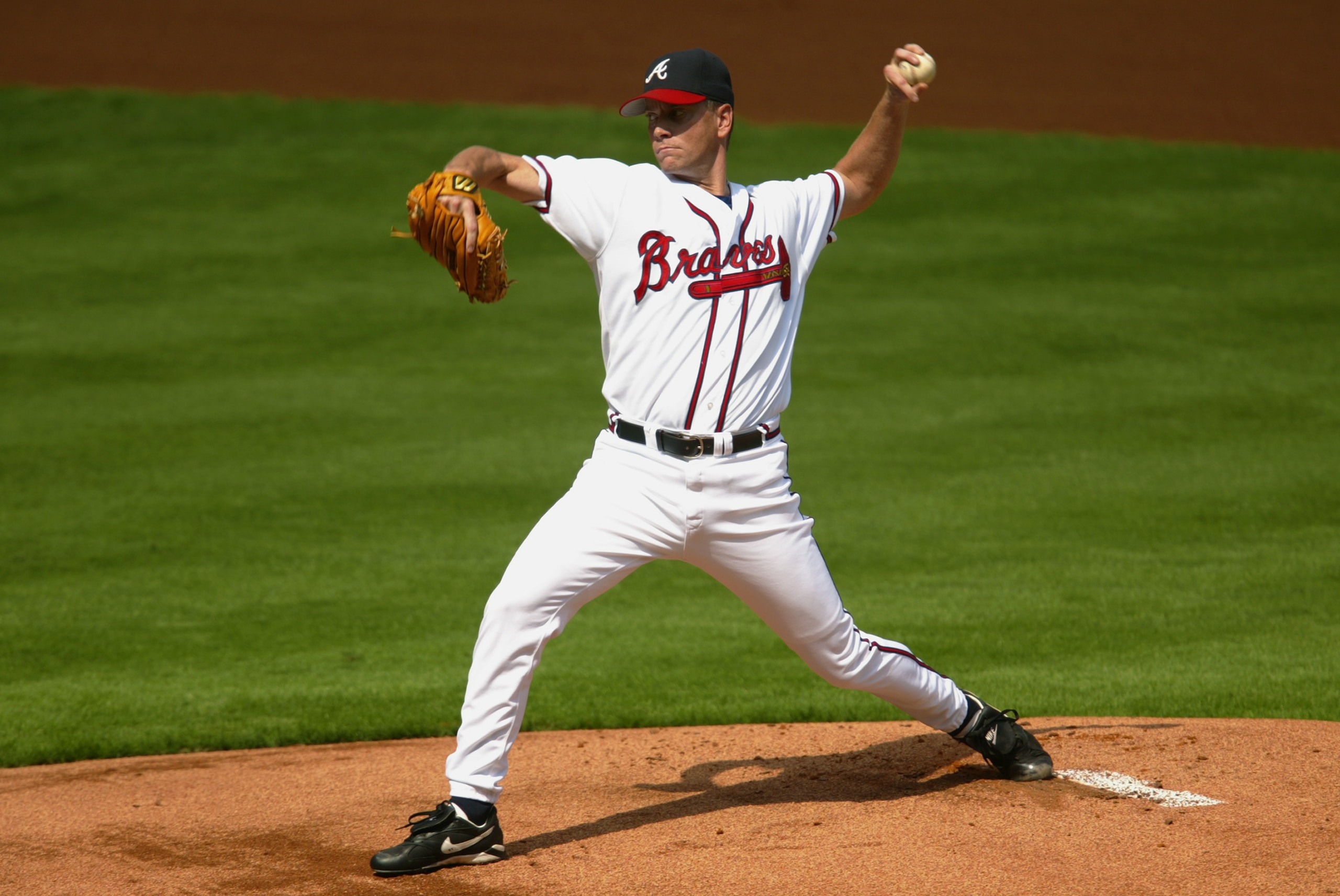 ATLANTA - OCTOBER 2:  Starting pitcher Tom Glavine #47 of the Atlanta Braves delivers a pitch in Game one of the National League Divisional Series against the San Francisco Giants at Turner Field on October 2, 2002 in Atlanta, Georgia. The Giants won 8-5.