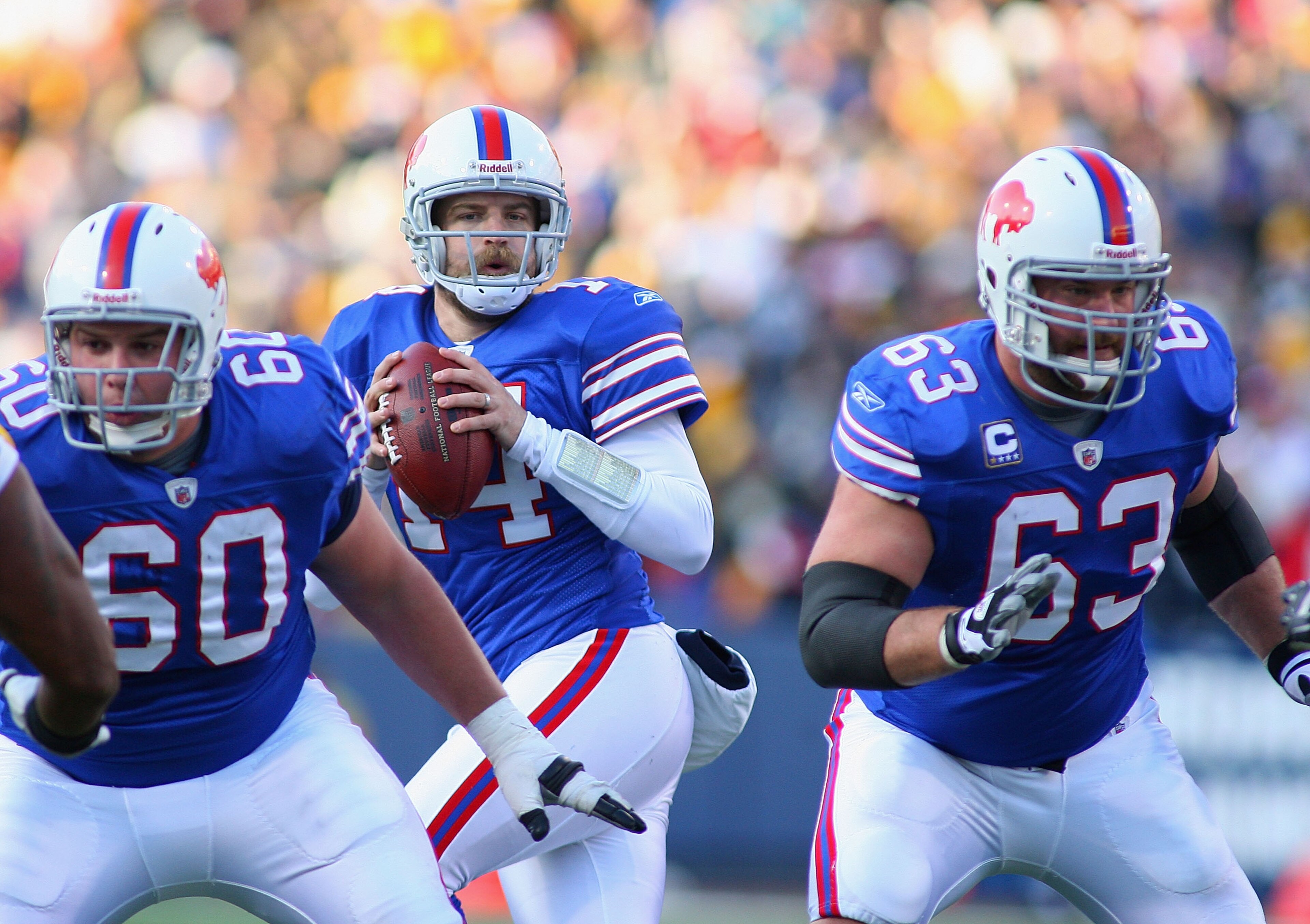 ORCHARD PARK, NY - NOVEMBER 28:  Ryan Fitzpatrick #14  of the Buffalo Bills drops back to throw with protection from Kraig Urbik #60 and Geoff Hangartner #63  against the Pittsburgh Steelers at Ralph Wilson Stadium on November 28, 2010 in Orchard Park, Ne