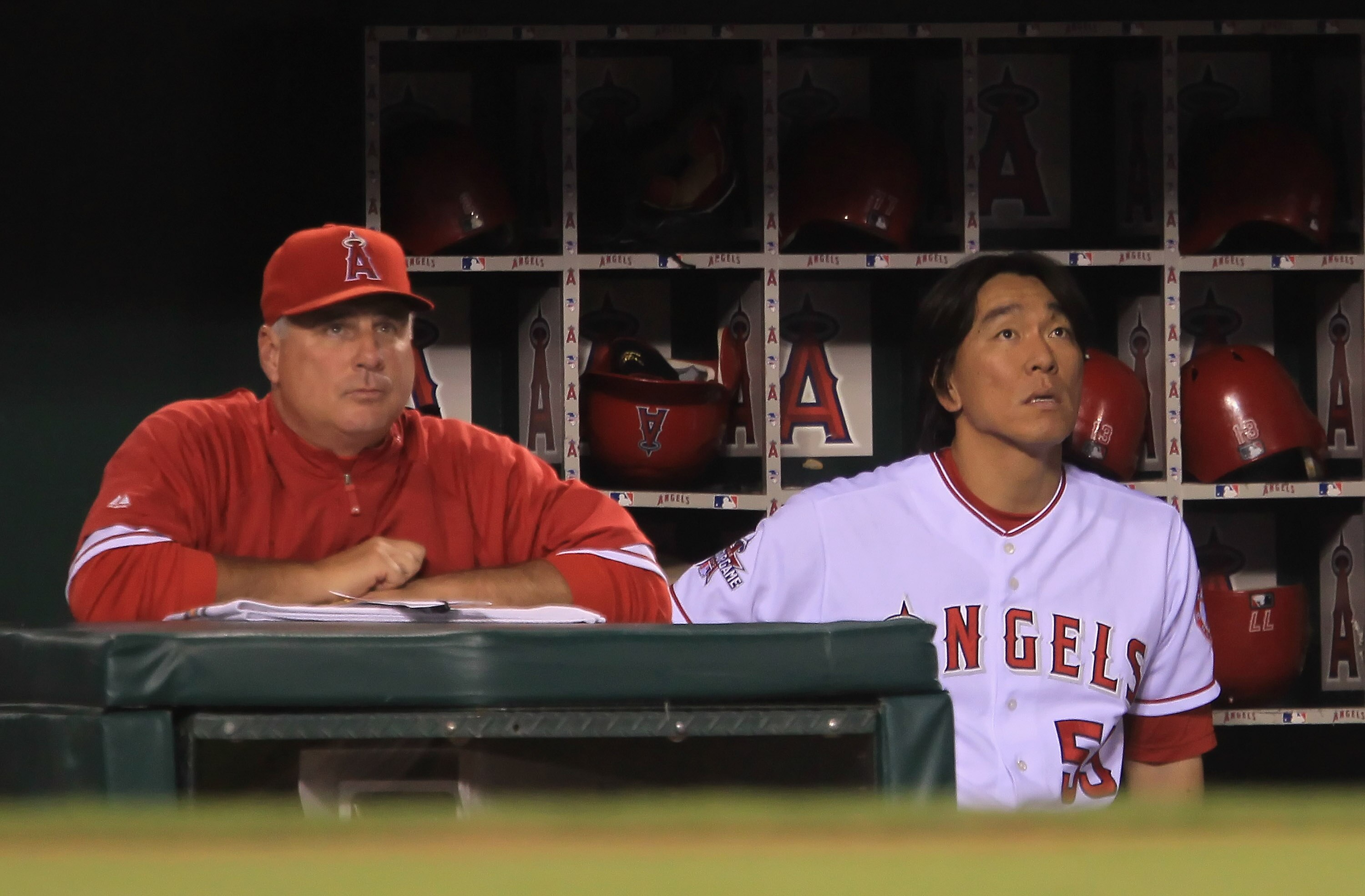 ANAHEIM, CA - SEPTEMBER 07:  Hideki Matsuil #55 of the Los Angeles Angels of Anaheim looks on from the dugout alongside manager Mike Scioscia after being forced out at second base in the seventh inning against the Cleveland Indians at Angel Stadium on Sep