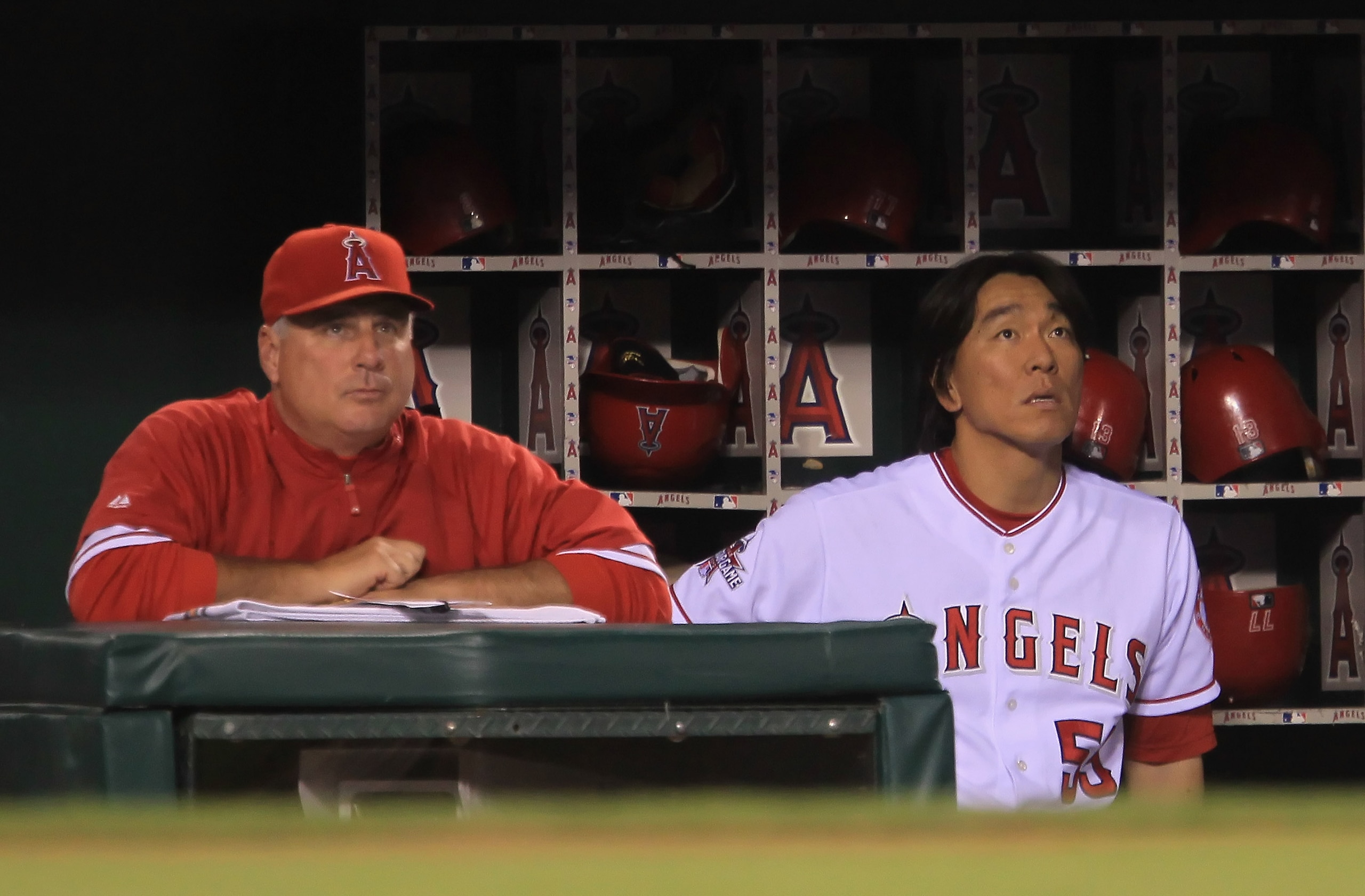 ANAHEIM, CA - SEPTEMBER 07:  Hideki Matsuil #55 of the Los Angeles Angels of Anaheim looks on from the dugout alongside manager Mike Scioscia after being forced out at second base in the seventh inning against the Cleveland Indians at Angel Stadium on Sep