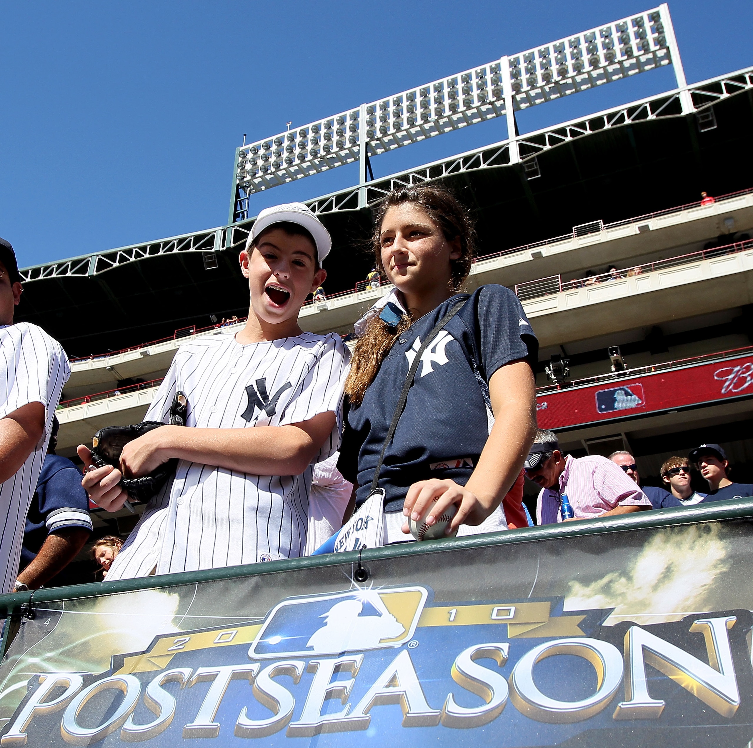 ARLINGTON, TX - OCTOBER 16:  Young fans of the New York Yankees show support for their team against the Texas Rangers in Game Two of the ALCS during the 2010 MLB Playoffs at Rangers Ballpark in Arlington on October 16, 2010 in Arlington, Texas.  (Photo by
