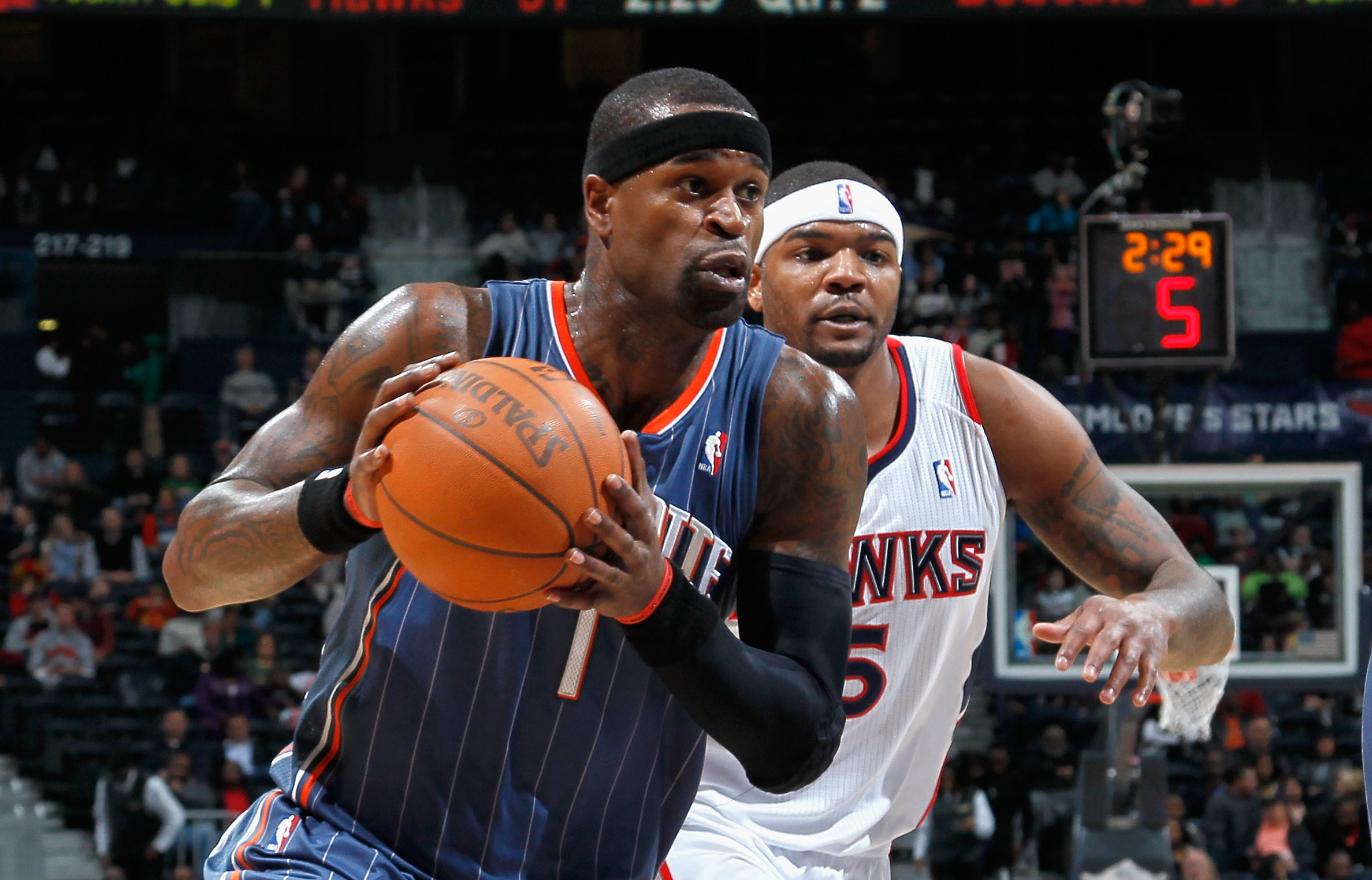 ATLANTA, GA - FEBRUARY 12:  Stephen Jackson #1 of the Charlotte Bobcats drives past Josh Smith #5 of the Atlanta Hawks at Philips Arena on February 12, 2011 in Atlanta, Georgia.  NOTE TO USER: User expressly acknowledges and agrees that, by downloading an