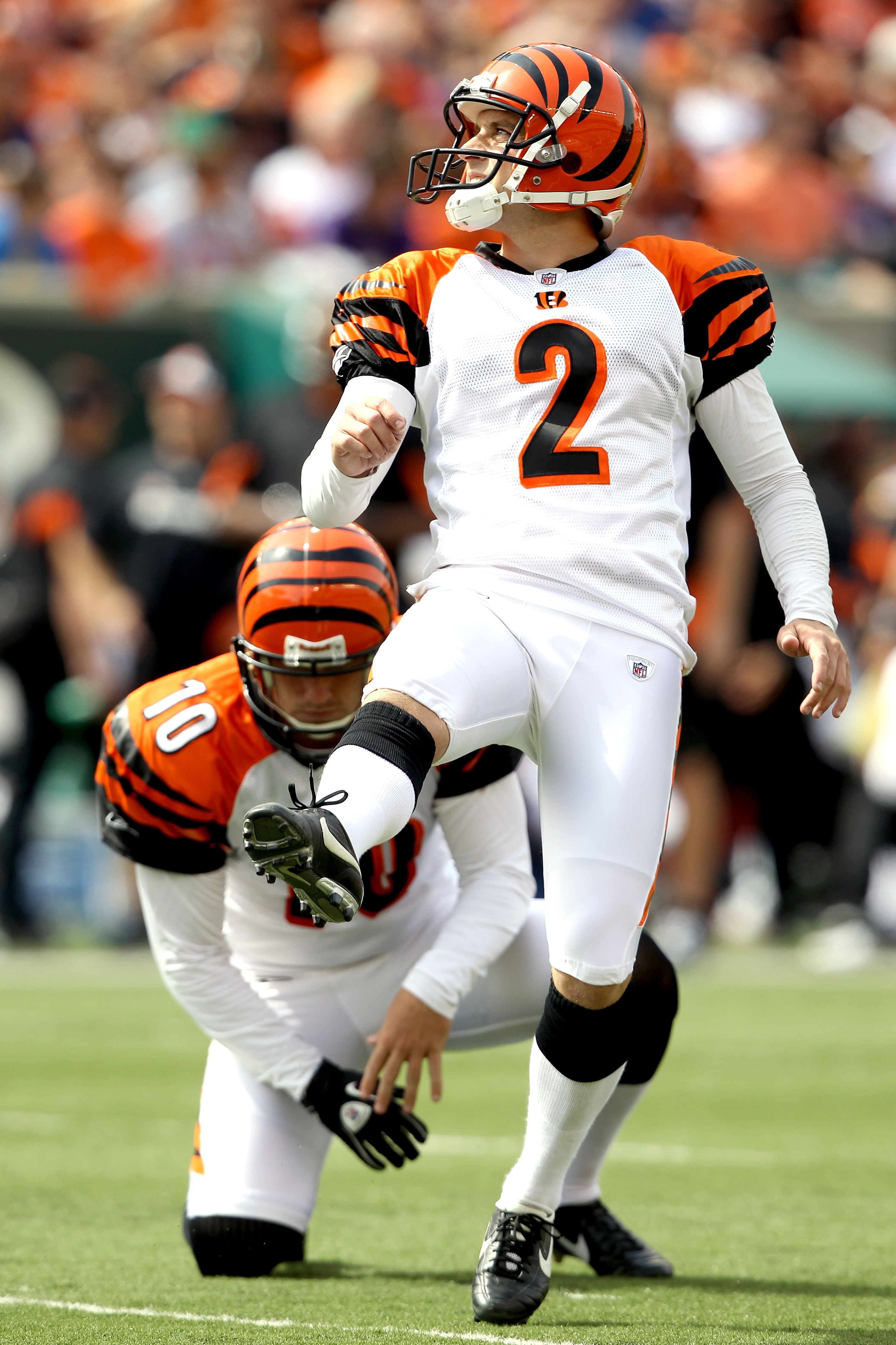 CINCINNATI - SEPTEMBER 19: Mike Nugent #2 of the Cincinatti Bengals kicks a field goal against the Baltimore ravens at Paul Brown Stadium on September 19, 2010 in Cincinnati, Ohio. The holder is Kevin Huber #10.  (Photo by Matthew Stockman/Getty Images)