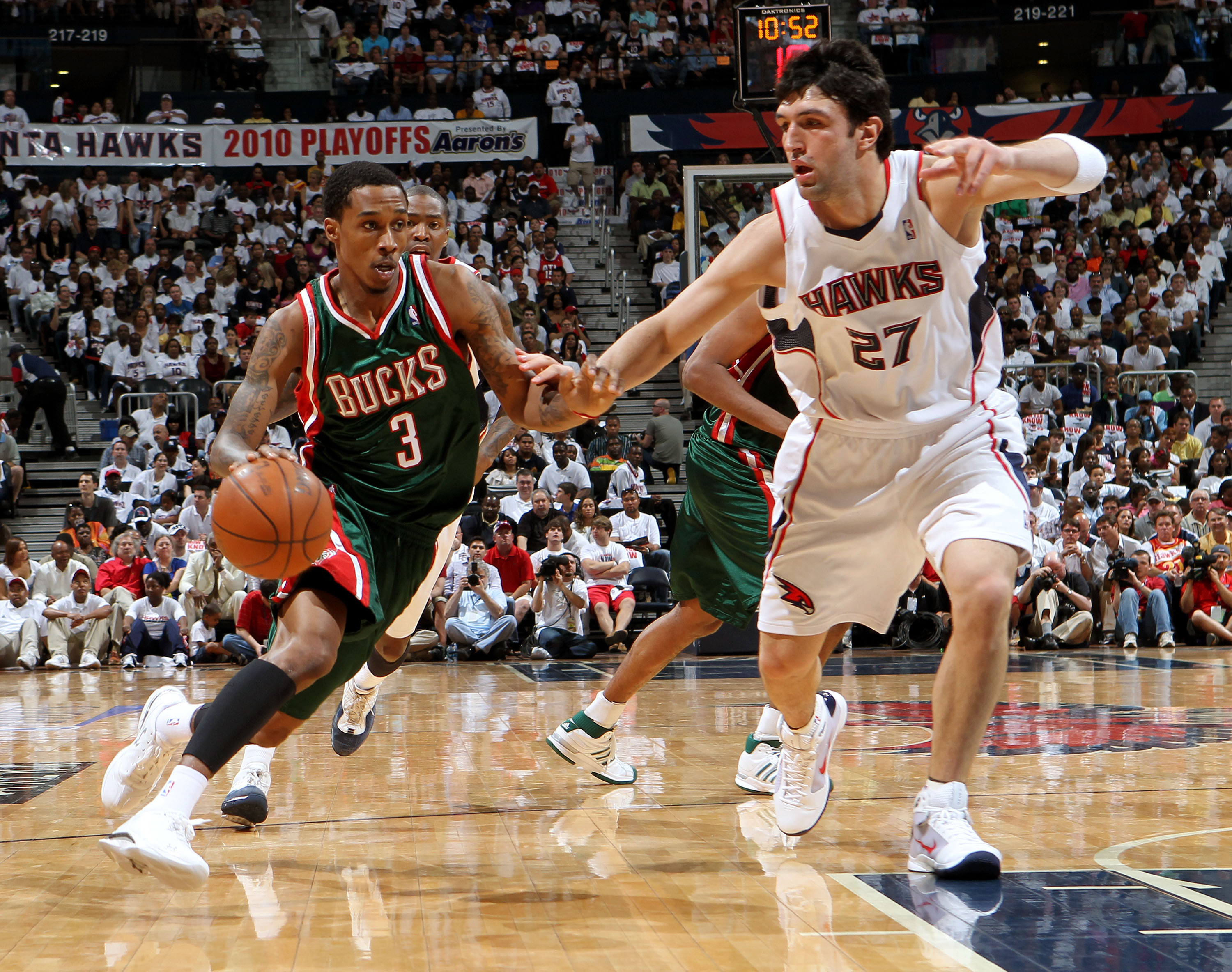 ATLANTA - MAY 2:  Guard Brandon Jennings #3 of the Milwaukee Bucks dribbles past center Zaza Pachulia #27 of the Atlanta Hawks during Game Seven of the Eastern Conference Quarterfinals between the Milwaukee Bucks and the Atlanta Hawks during the 2010 NBA