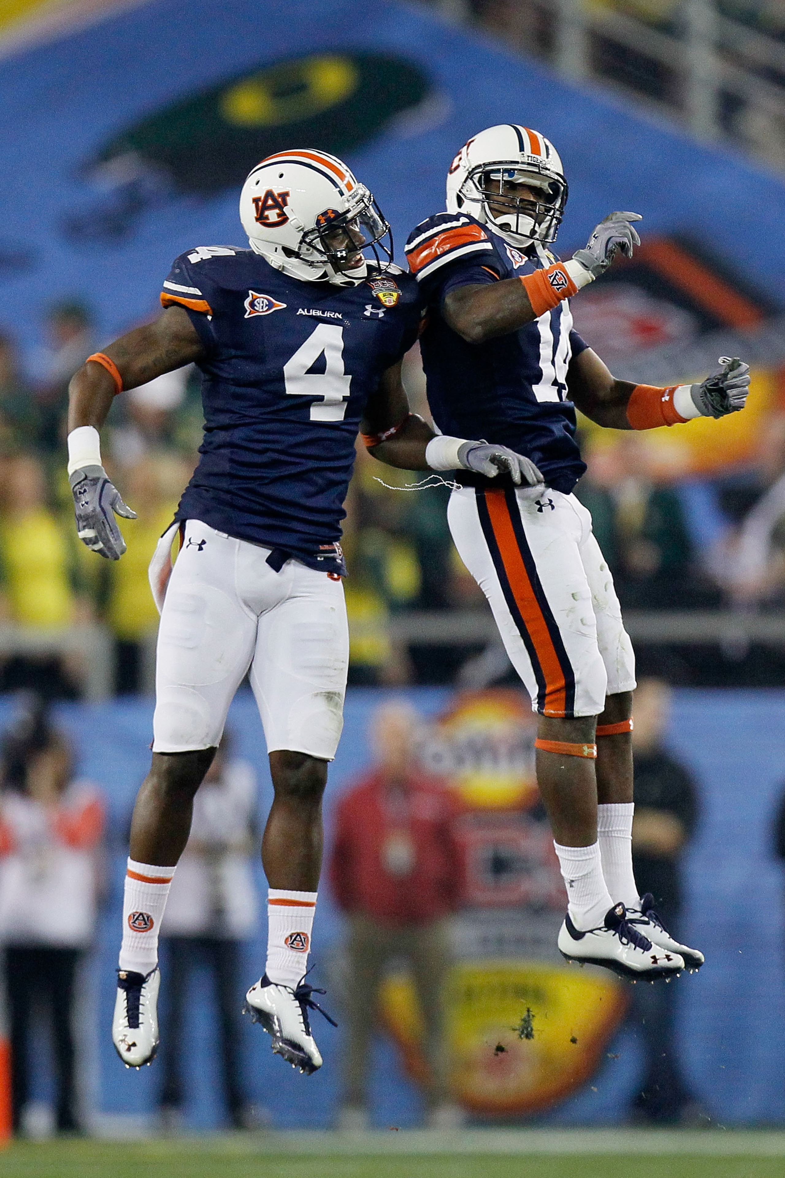 GLENDALE, AZ - JANUARY 10:  Zac Etheridge #4 and Demond Washington #14 of the Auburn Tigers celebrate against the Oregon Ducks during the Tostitos BCS National Championship Game at University of Phoenix Stadium on January 10, 2011 in Glendale, Arizona.  (