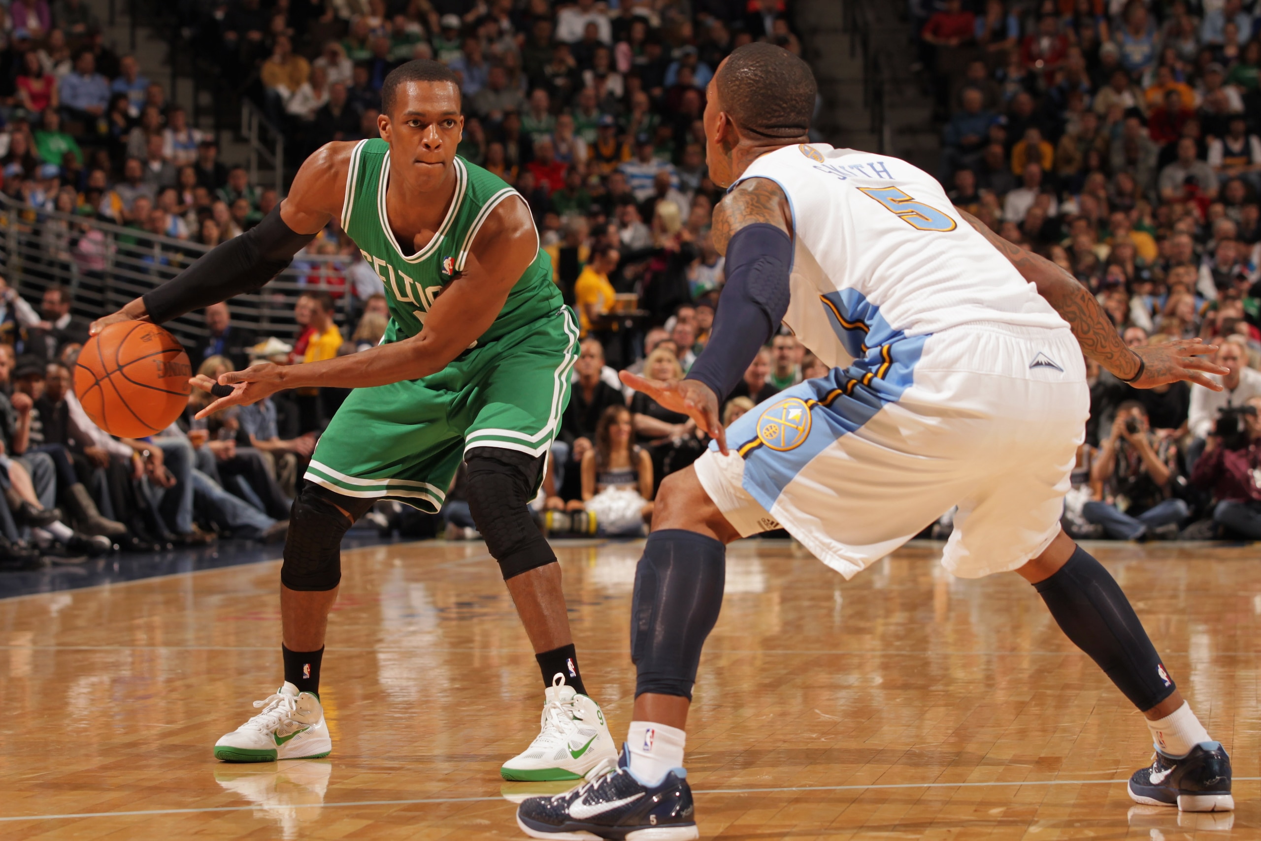 DENVER, CO - FEBRUARY 24:  Rajon Rondo #9 of the Boston Celtics controls the ball against J.R. Smith #5 of the Denver Nuggets during NBA action at the Pepsi Center on February 24, 2011 in Denver, Colorado. NOTE TO USER: User expressly acknowledges and agr